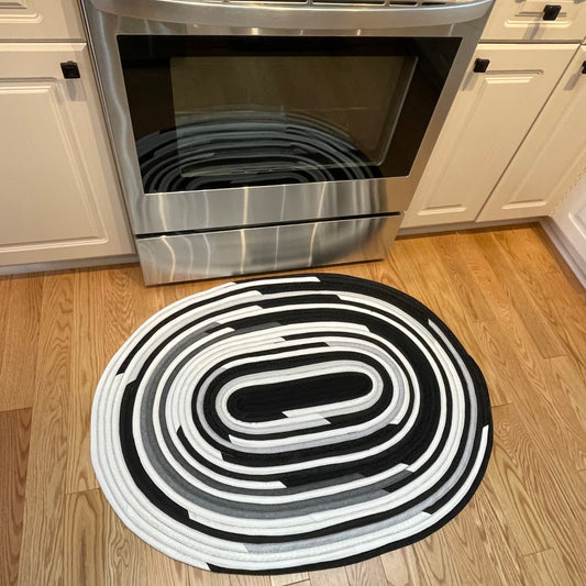 Handmade Kitchen Jelly Roll Rug.  Featuring black, grey and white tones of quilting cotton.  Washable and durable this rug will last for years. Handmade in Canada by Home Stitchery Decor