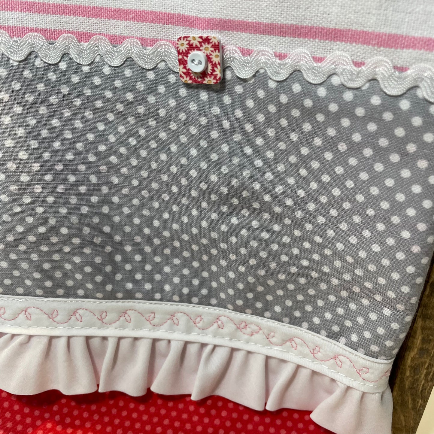 Fun Retro Pink Polka Dot Dish Towel. White, Pink, Red Toweling with polka dot quilting fabric, ric rac, frilled broadcloth and button embellishments. Topped off with some floral embroidery stitching. Part of a coordinated collection of farmhouse fabulous decor. Shop the entire collection. And be sure to follow along on the Home Stitchery Decor YouTube Channel where the farmhouse diy decor fun never stops!