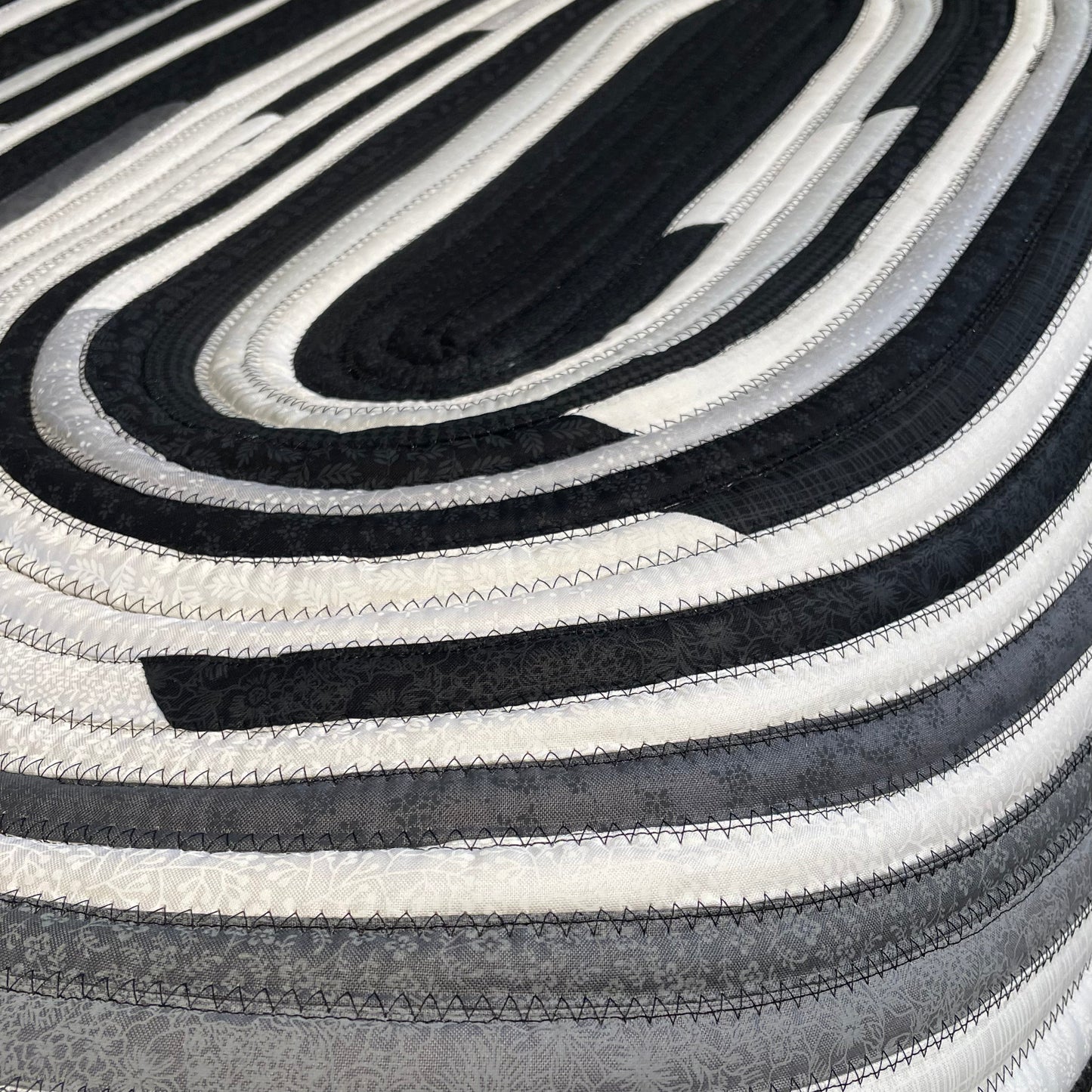 Handmade Kitchen Jelly Roll Rug. Featuring black, grey and white tones of quilting cotton. Washable and durable this rug will last for years. Handmade in Canada by Home Stitchery Decor