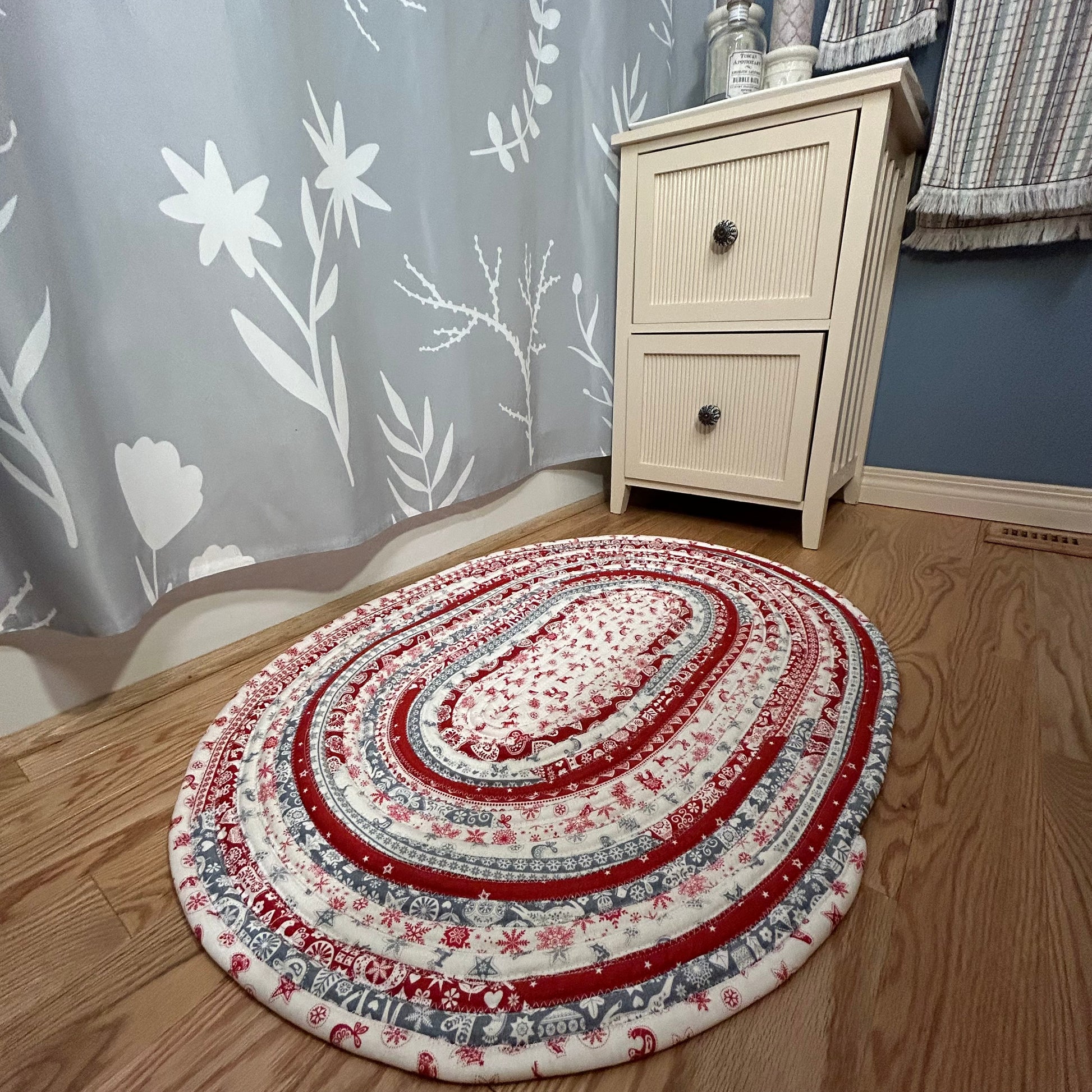 Handmade Christmas Kitchen Rug. Washable Cotton Jelly Roll Rug for Kitchen, Bedside or Bathmat. Featuring premium quilt cotton with red, white and grey Christmas prints. Made in Canada