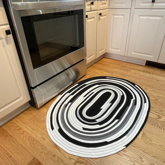Handmade Kitchen Jelly Roll Rug. Featuring black, grey and white tones of quilting cotton. Washable and durable this rug will last for years. Handmade in Canada by Home Stitchery Decor