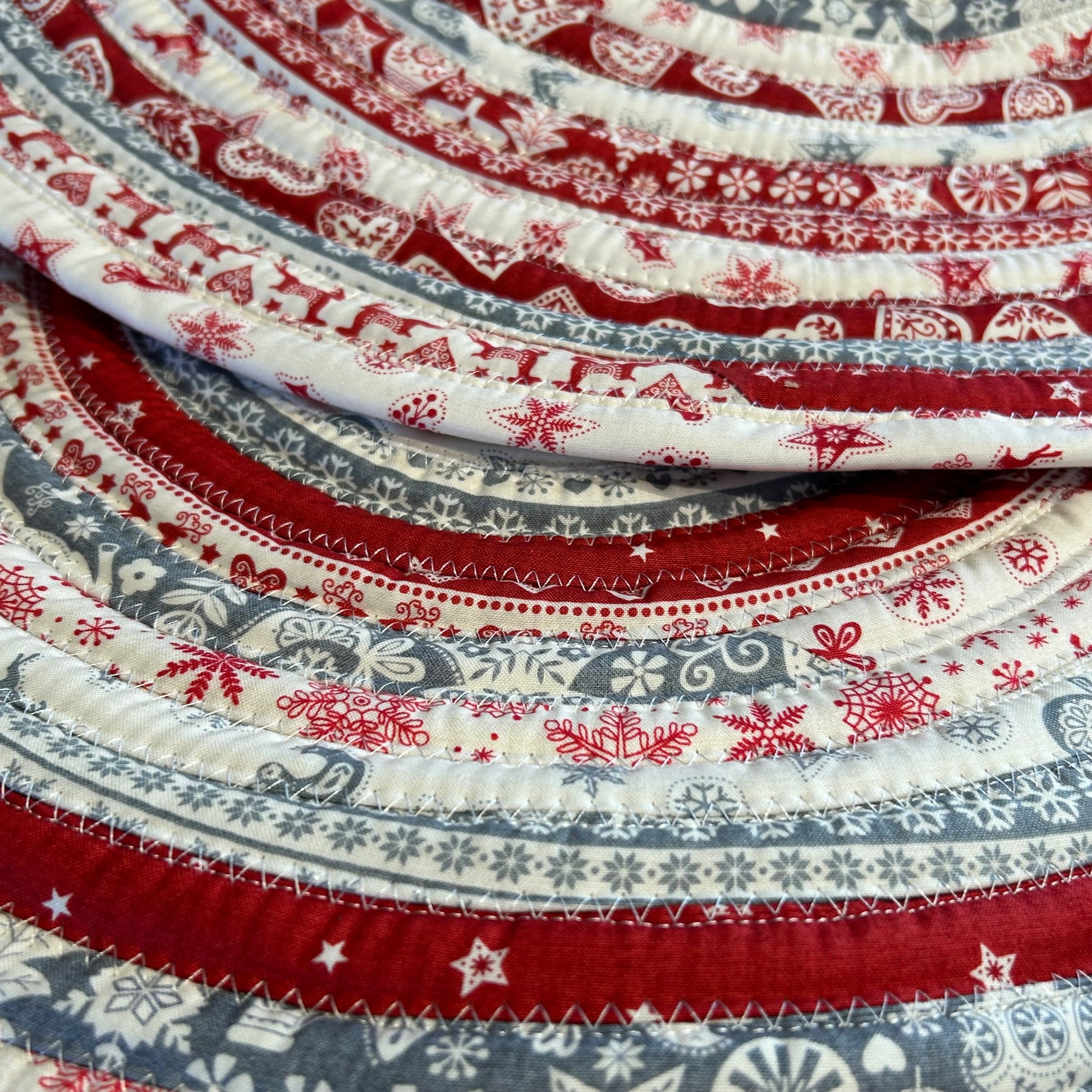 Handmade Christmas Kitchen Rug. Washable Cotton Jelly Roll Rug for Kitchen, Bedside or Bathmat. Featuring premium quilt cotton with red, white and grey Christmas prints. Made in Canada