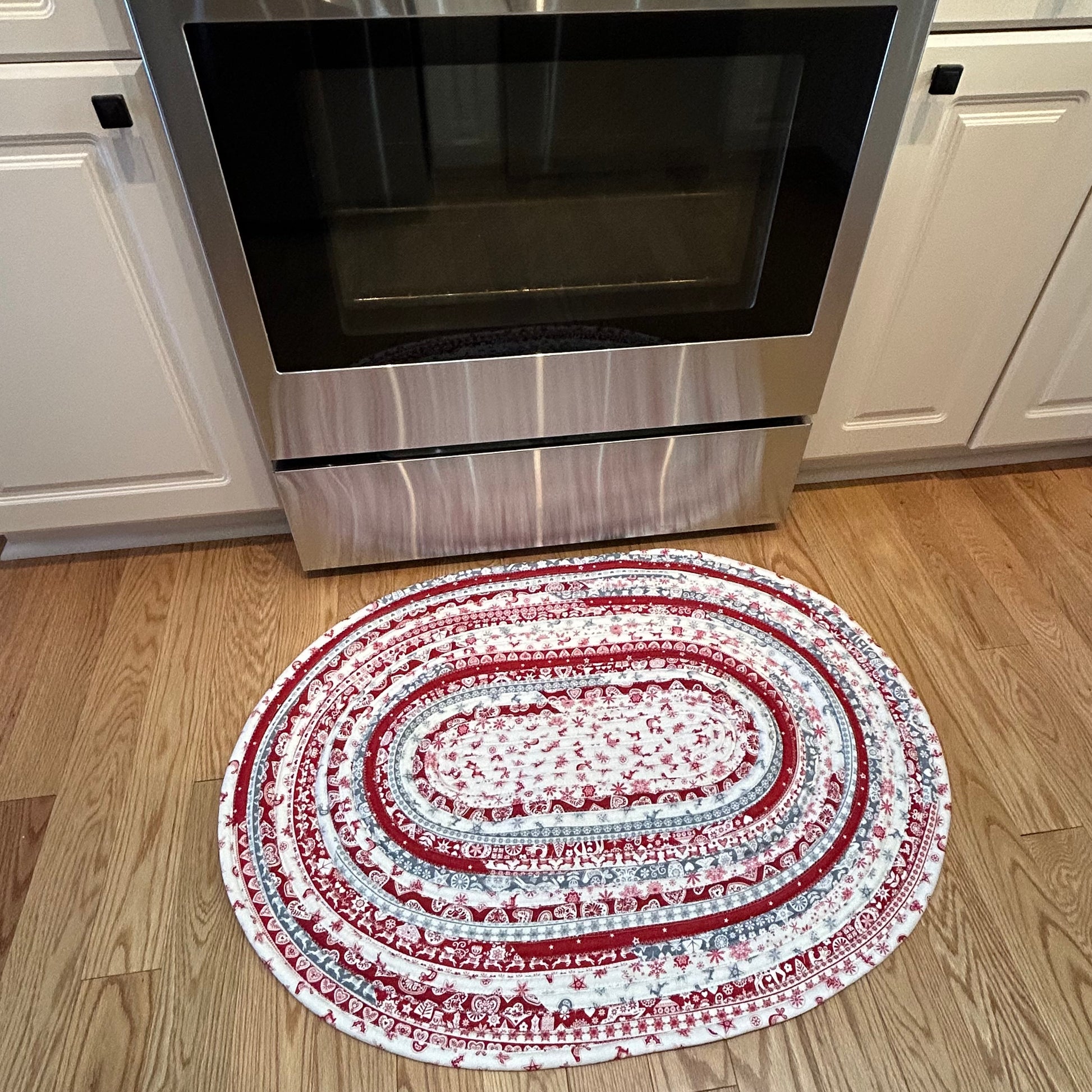 Handmade Christmas Kitchen Rug. Washable Cotton Jelly Roll Rug for Kitchen, Bedside or Bathmat. Featuring premium quilt cotton with red, white and grey Christmas prints. Made in Canada