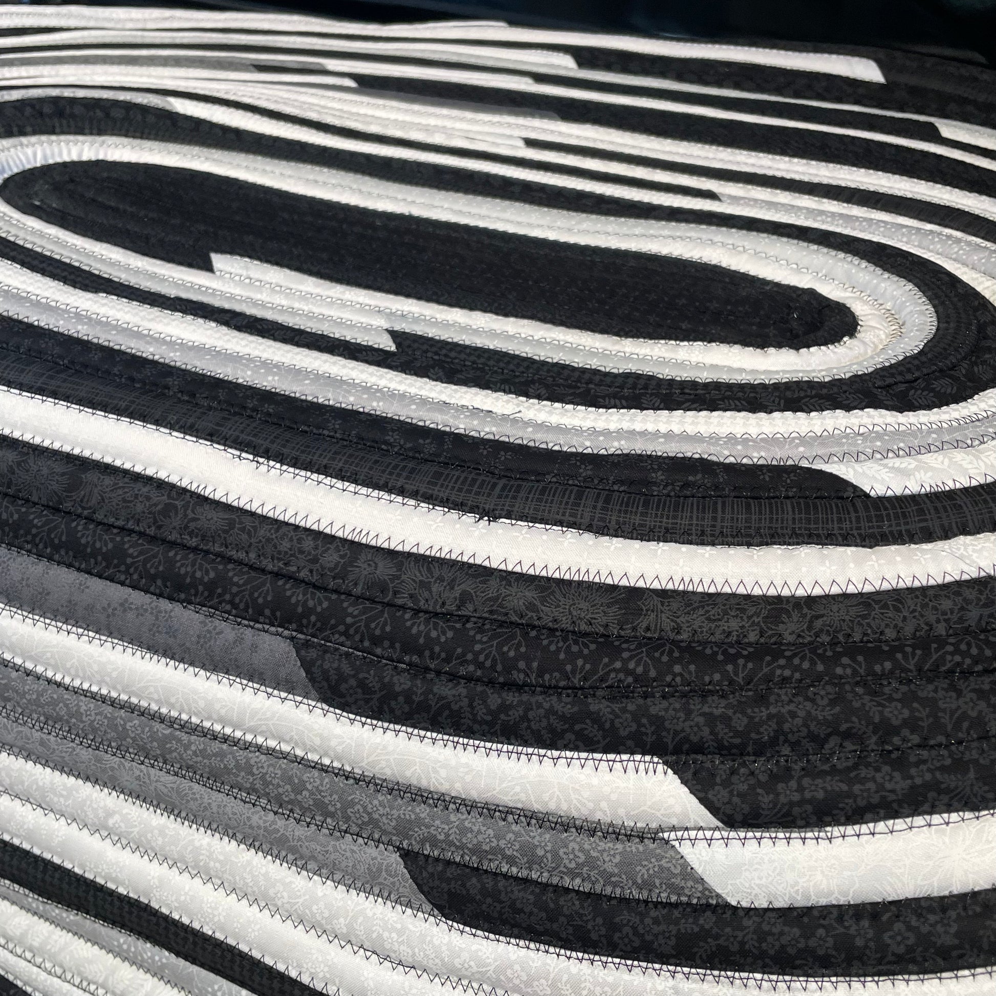 Handmade Kitchen Jelly Roll Rug. Featuring black, grey and white tones of quilting cotton. Washable and durable this rug will last for years. Handmade in Canada by Home Stitchery Decor