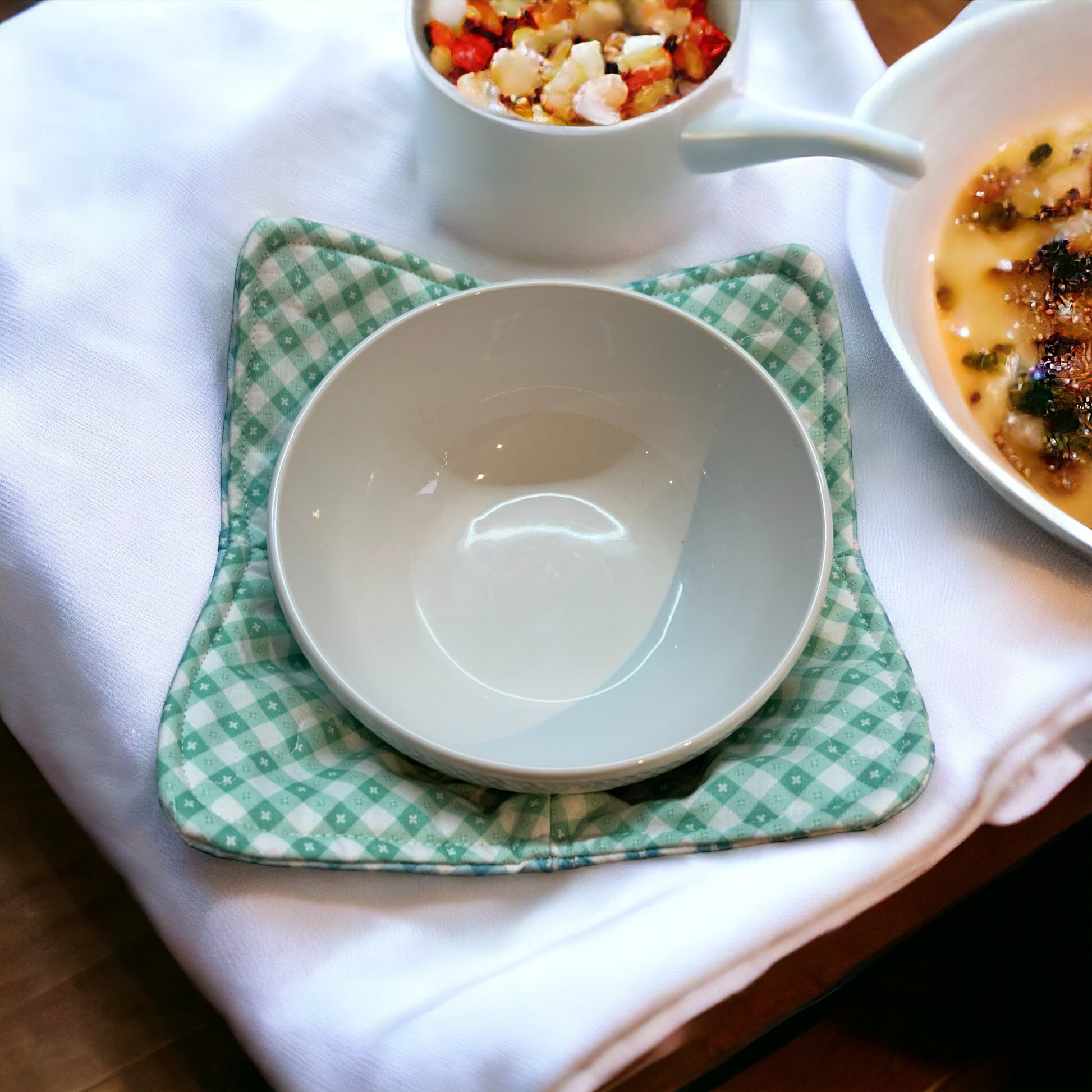 Checkered Kitchen Soup Bowl Cozy for Hot Soup Bowl. Reversible and washable this cute cozy is made with green and blue checkered quilt cotton and Pellon Wrap and Zap Batting.