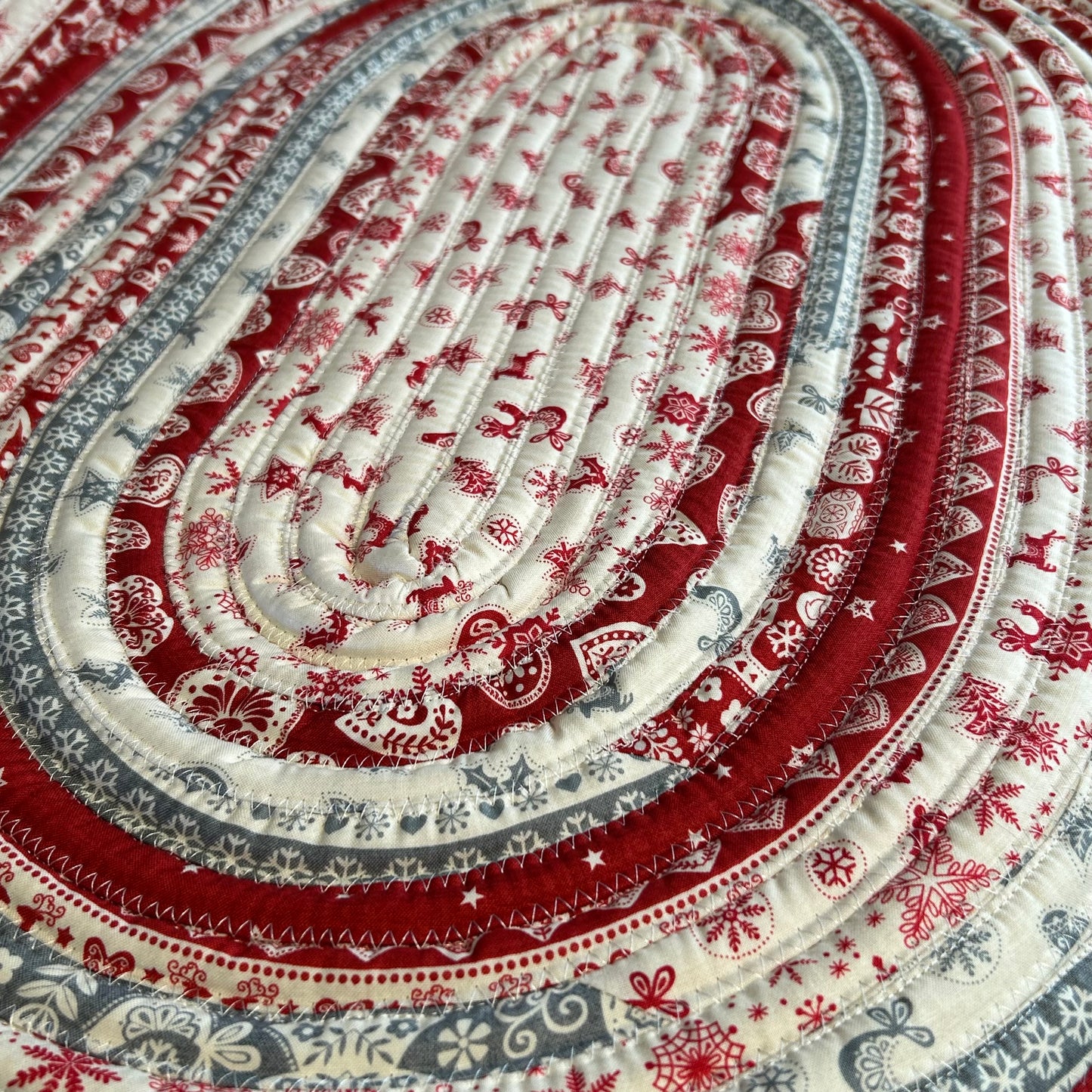 Handmade Christmas Kitchen Rug. Washable Cotton Jelly Roll Rug for Kitchen, Bedside or Bathmat. Featuring premium quilt cotton with red, white and grey Christmas prints. Made in Canada