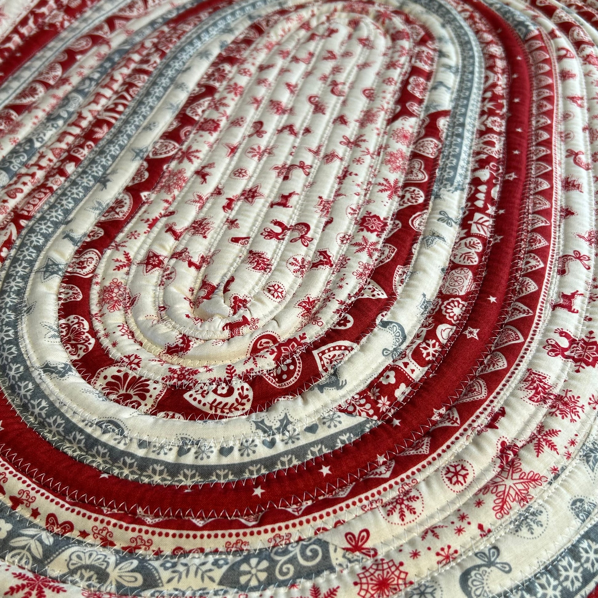 Handmade Christmas Kitchen Rug. Washable Cotton Jelly Roll Rug for Kitchen, Bedside or Bathmat. Featuring premium quilt cotton with red, white and grey Christmas prints. Made in Canada