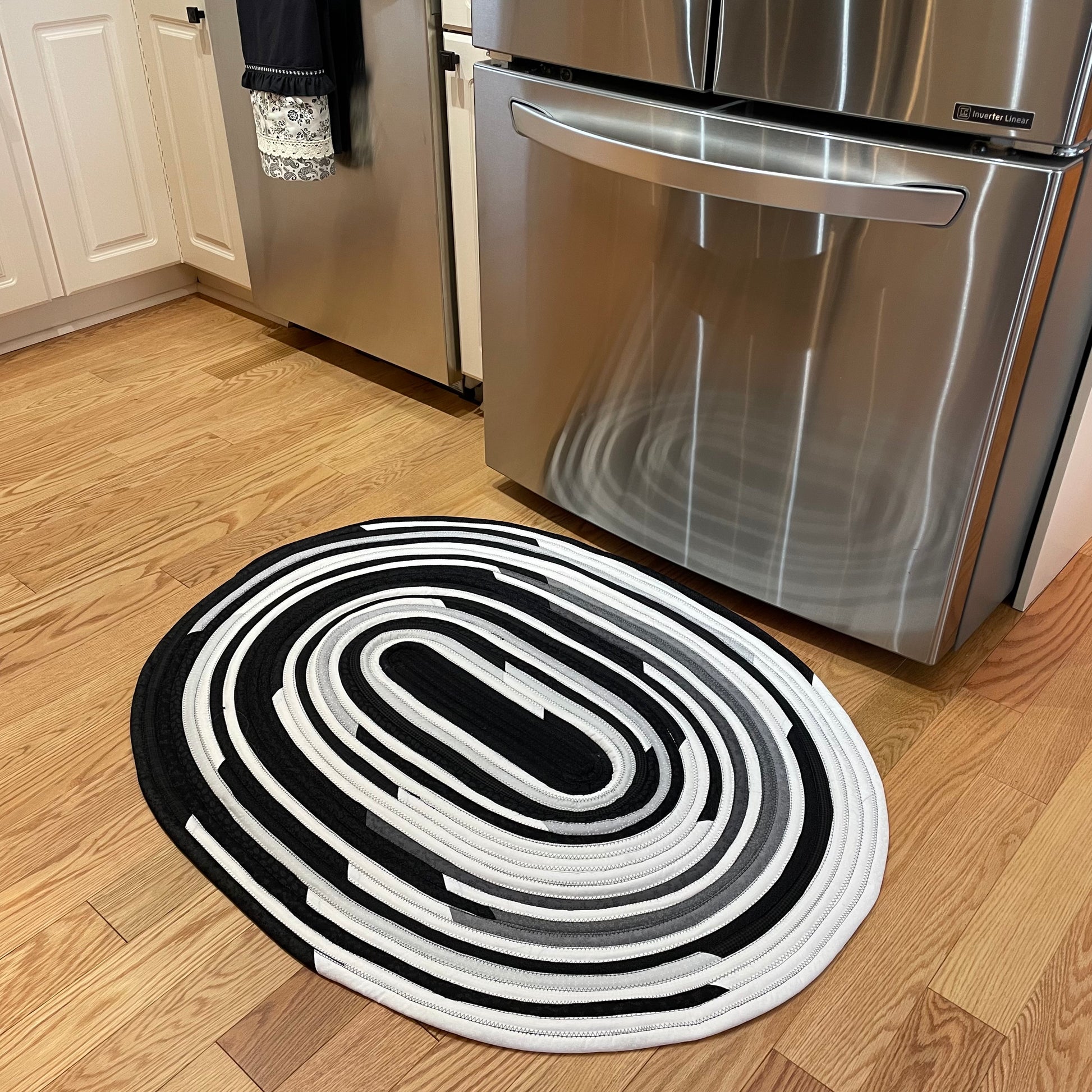 Handmade Kitchen Jelly Roll Rug. Featuring black, grey and white tones of quilting cotton. Washable and durable this rug will last for years. Handmade in Canada by Home Stitchery Decor