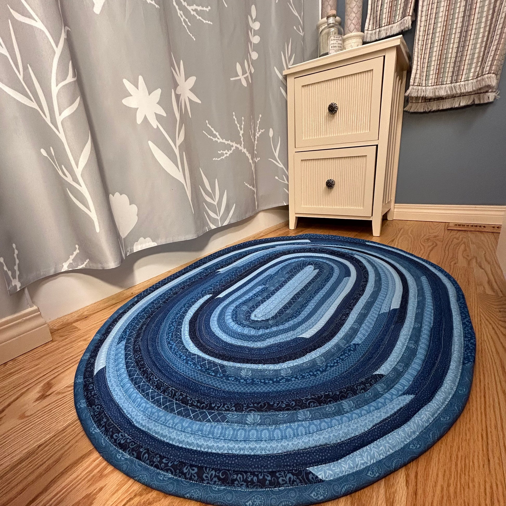 Blue Handmade Jelly Roll Rug for Kitchen. Or use as a bedside rug or luxury bathmat. It's cozy, washable, reversible and made to last. At Home Stitchery Decor we aim to bring beauty and function to home decor just like grandma used to make!