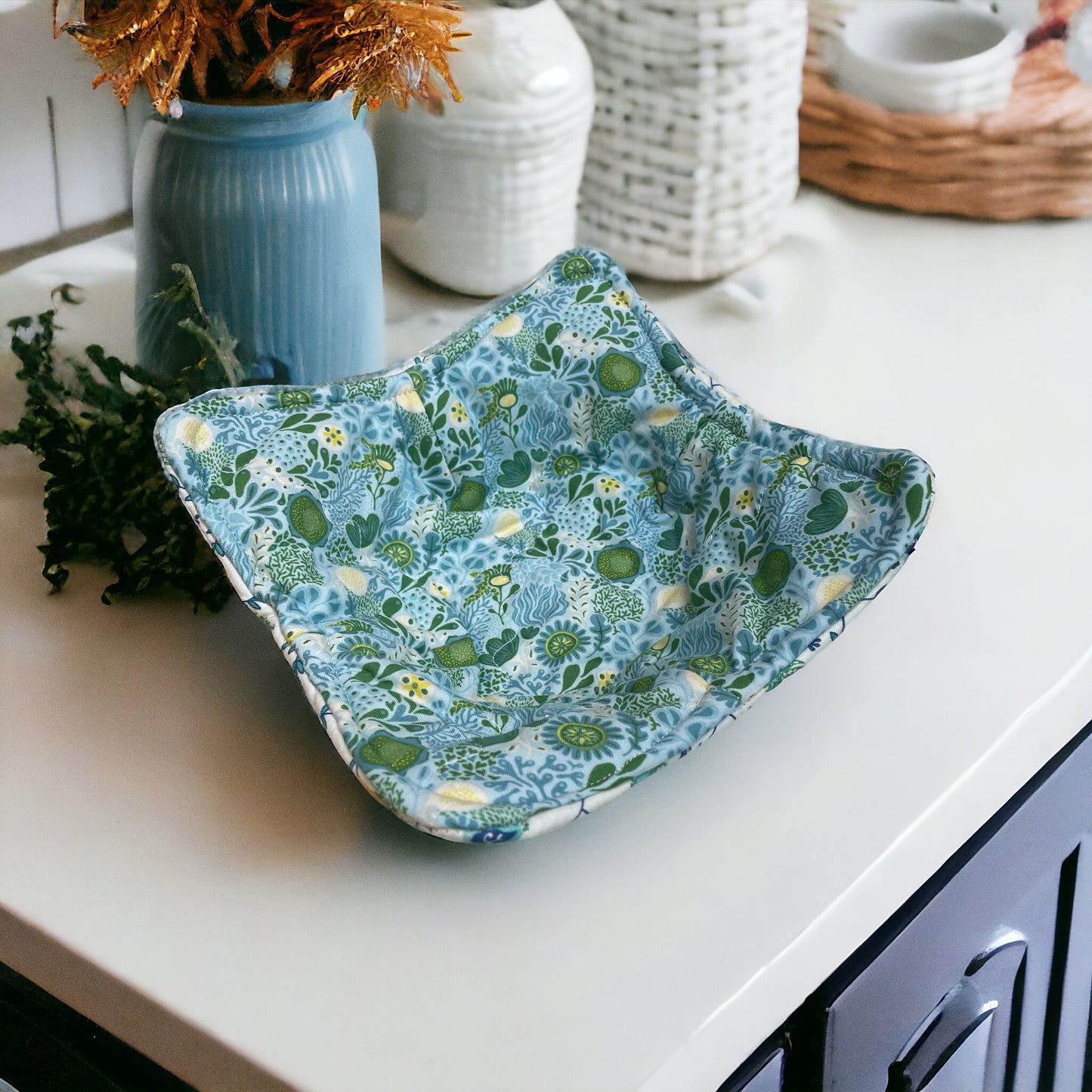 Rooster Kitchen Soup Bowl Cozy. Featuring teal and green rooster print cotton fabric on one side and teal floral reverse side fabric. Batting is Pellon Wrap and Zap and it's sewn with cotton thread. Handmade in Canada