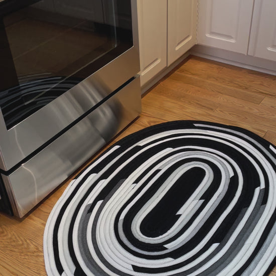 Handmade Kitchen Jelly Roll Rug. Featuring black, grey and white tones of quilting cotton. Washable and durable this rug will last for years. Handmade in Canada by Home Stitchery Decor