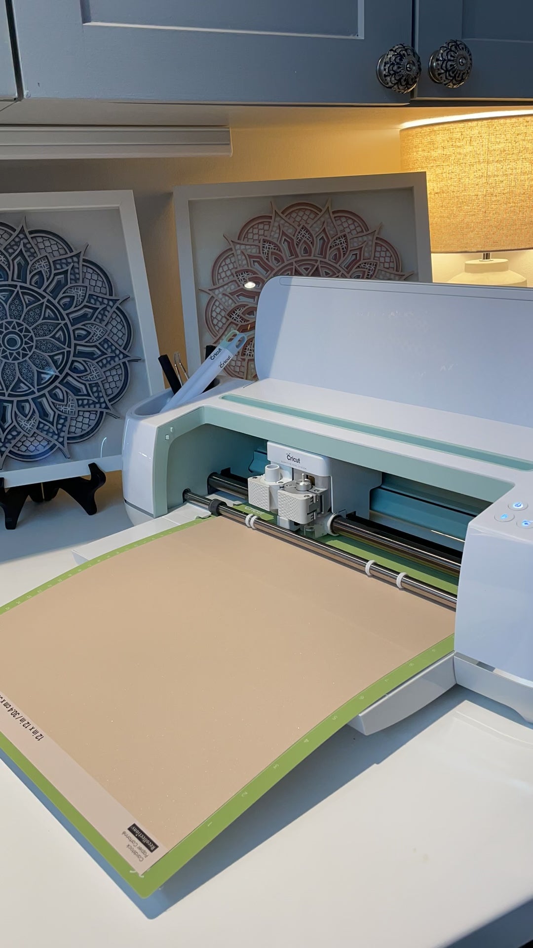 Time lapse video of cutting out a 3d Layered Mandala.  In the background are two framed Mandalas by Home Stitchery Decor.  SVG layered mandala designs for sale by Home Stitchery Decor.  Follow along with the complete 3D layered Mandala tutorail on the Home Stitchery Decor YouTube Channel