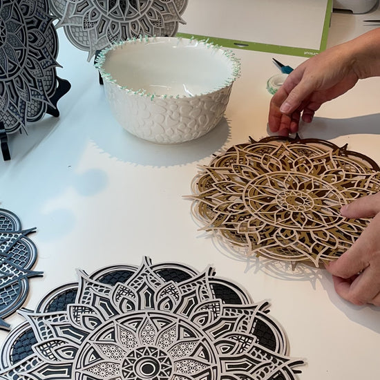Close up high speed video of creating a 3d layered Mandala.  Design is exclusive to Home Stitchery Decor and the instant download SVG file comes with a complete tutorial and supply lists for your crafting success.  I made this one with a Cricut but the files can be sized and used with larger laser machines. Check out all our 3d Layered Mandala Designs at Home Stitchery Decor