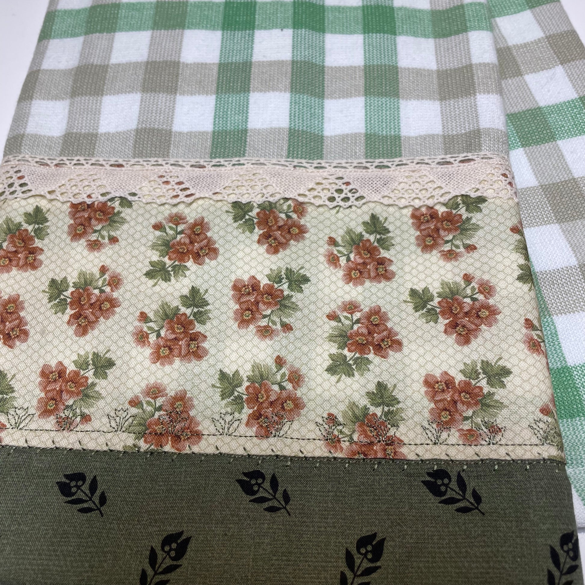 Farmhouse Dish Towel with green and white check towelins and orange and green cotton fabric decorations. Featuring embroidery stitching and beige cotton lace trim. Handcrafted in Canada by Home Stitchery Decor. Purchased coordinating Farmhouse Decor or follow along with tutorials on the Home Stitchery Decor YouTube Channel. 