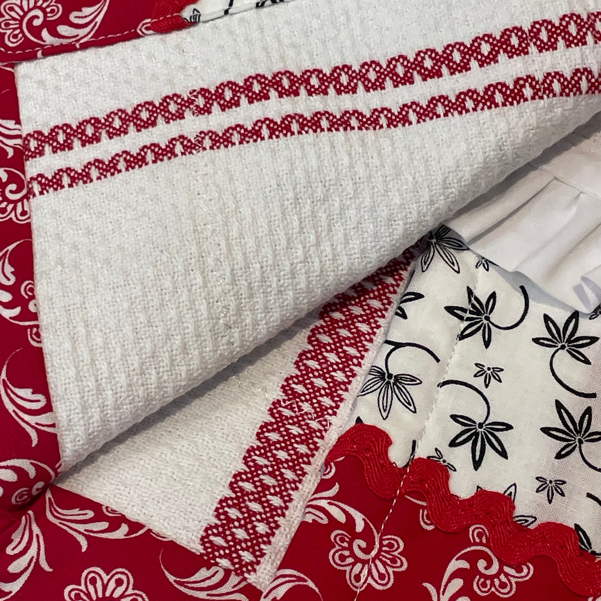 Red and white country style dish towel. Featuring red and white checked toweling; red white and black quilt cotton accents and white cotton lace trim and a double button embellishment. Part of a mix and match collection of coordinated farmhouse fabulous decor. Browse the collections and be sure to check out the Home Stitchery Decor YouTube Channel.
