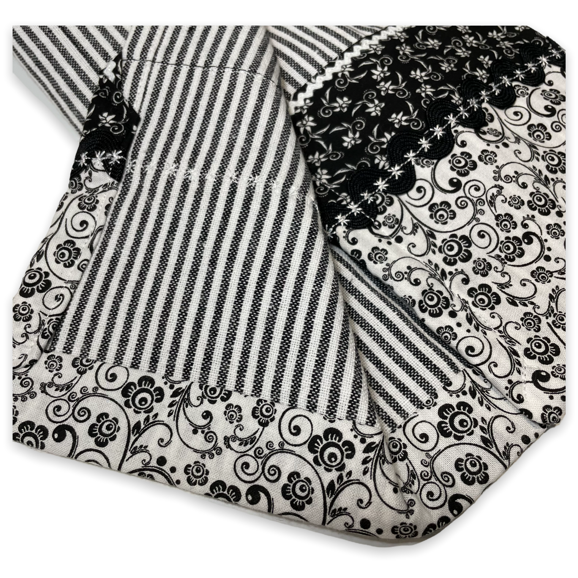 Black and white retro farmhouse tea towel. Featuring black and white striped toweling. Black and white floral quilting cotton accents with white and black ric rac, a handcrafted flower with button center and embroidery stitching. Part of a coordinating collection of farmhouse decor. Browse the entire collection. Then head over to the Home Stitchery Decor YouTube Channel for more Farmhouse DIY Decor Fun. See you there!