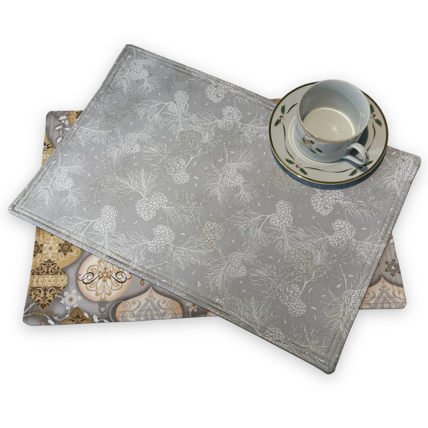 Reversible Christmas Placemats Featuring Gold and Silver Ornaments on one side and Silver Pinecones on the opposite side. Luxurious handmade Christmas Table Placemats. Part of a collection by Home Stitchery Decor. Check out all the mix and match items online.