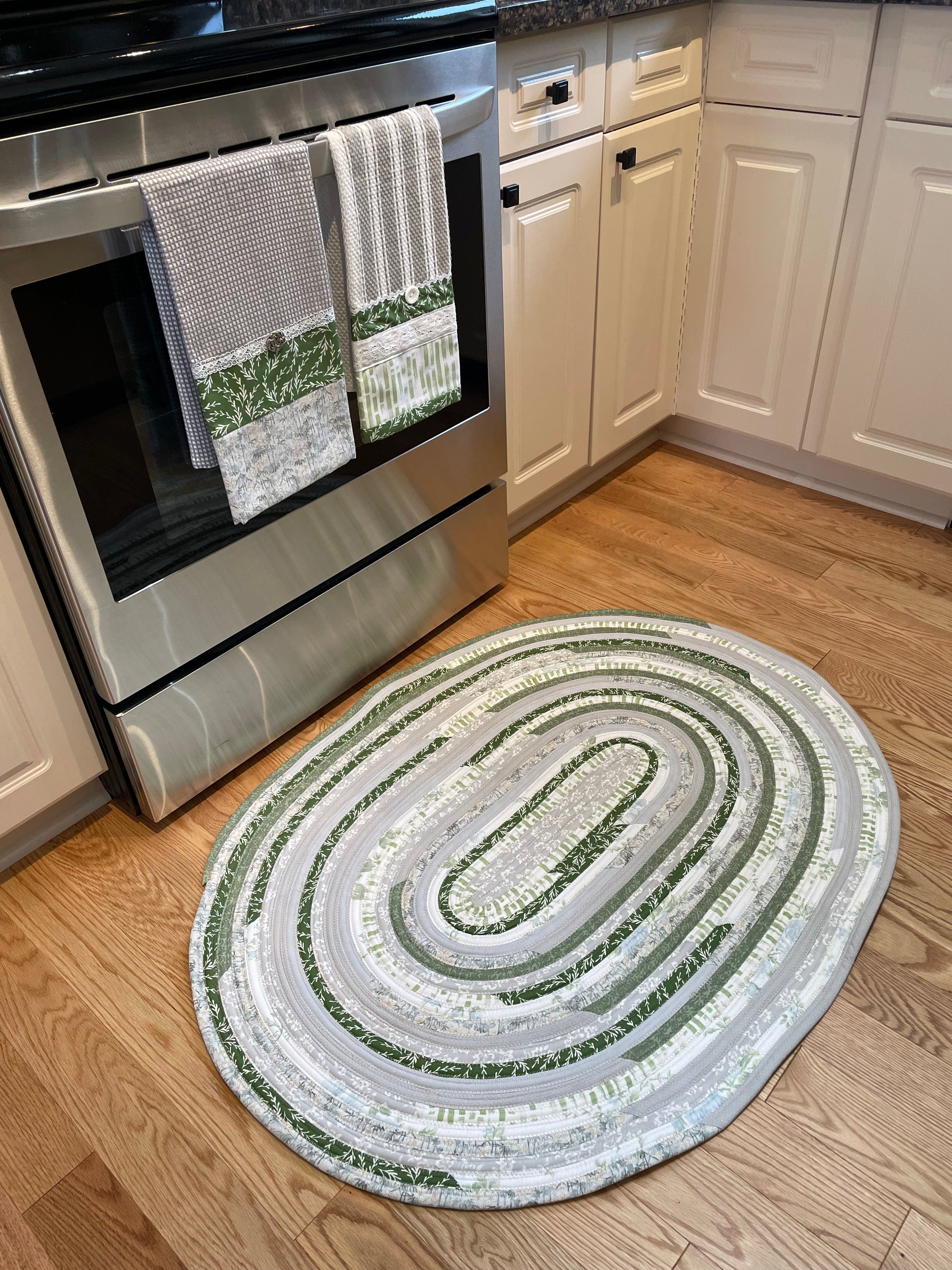 Green and grey cotton kitchen, bedside or bathmat accent rug.  Washable and handcrafted exclusively by Home Stitchery Decor.  Part of a mix and match collection. Features high quality quilting cotton exterior and Pellon Batting fill.  One of a kind.