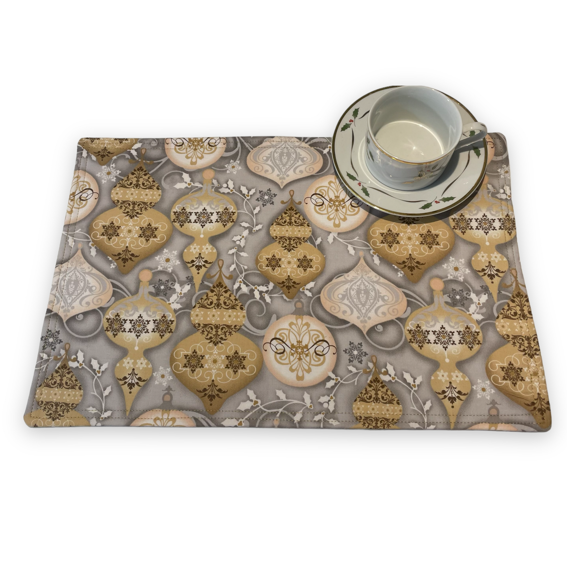 Set of two Christmas Placemats, handmade in Canada Featuring Gold and Cream Christmas Ornaments on one side and Silver Snowflakes on the reverse. Easily dress up your Christmas Kitchen Table with these stylish luxury placemats. Check out all the mix and match decor at Home Stitchery Decor