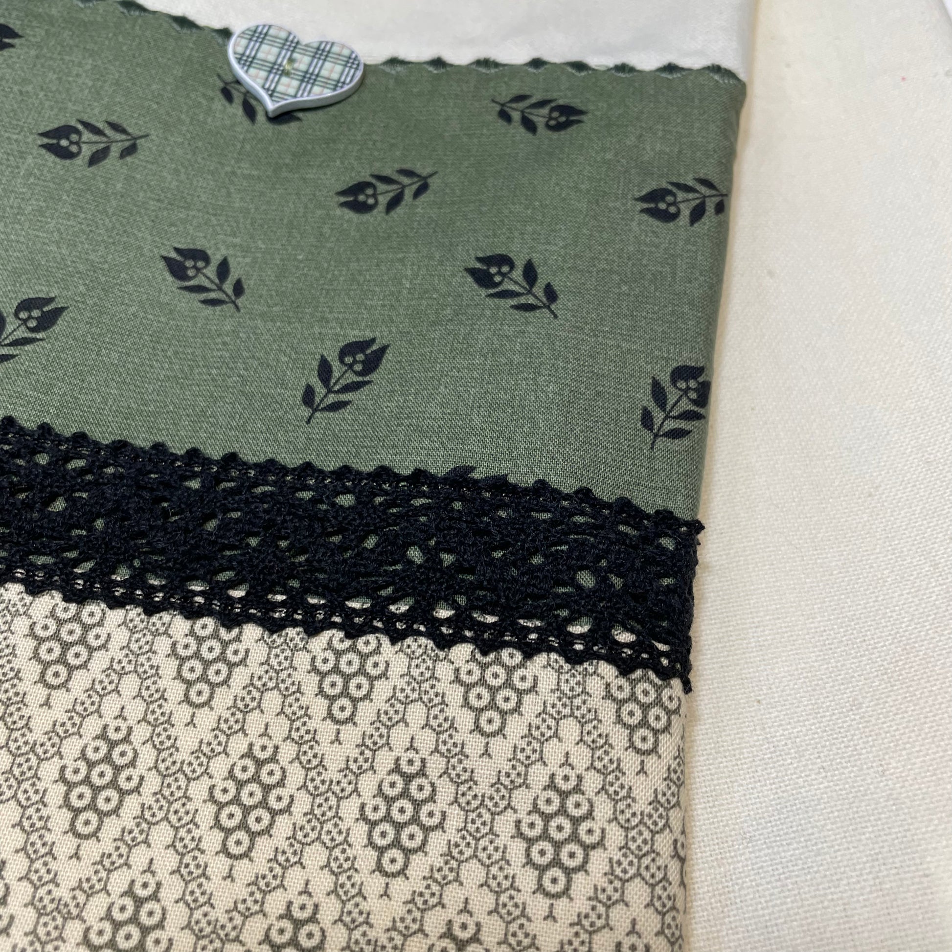 Vintage styled farmhouse dish towel. Cream cotton towel with green quilting cotton accents. Featuring black cotton lace trim, a gingham button and embroidery stitching. Part of a mix and match collection, browse your favorites! Then check out the Home Stitchery Decor YouTube Channel for more fabulous Farmhouse Fun DIY