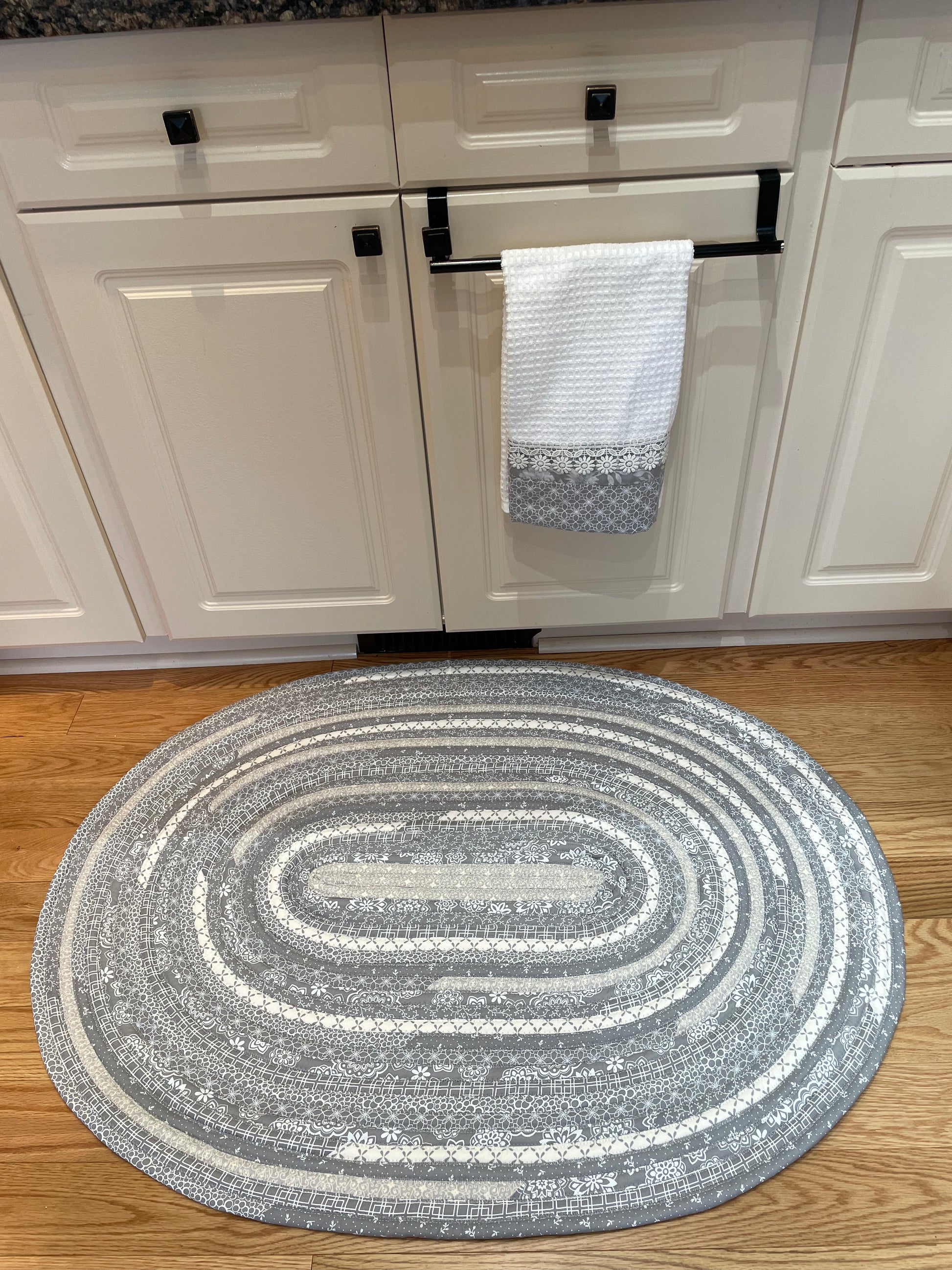 Grey and White Modern Farmhouse Kitchen Accent Rug. Can be used as a luxury bathmat, or bedside rug. Washable, Cotton and made in Canada with globally sourced supplies. Matching dish towels and shower curtains also available. Check out the Home Stitchery Decor YouTube Channel.