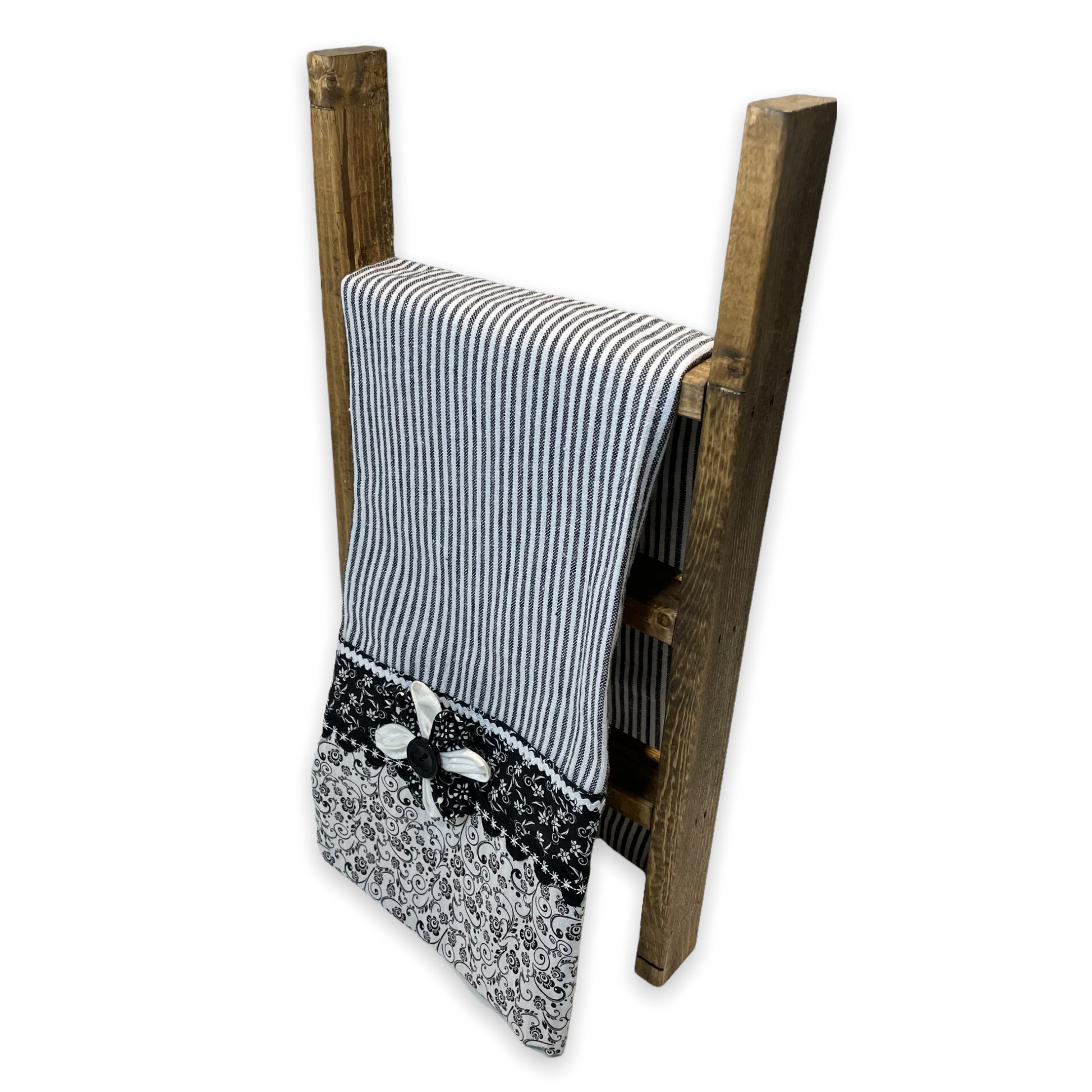 Black and white retro farmhouse tea towel. Featuring black and white striped toweling. Black and white floral quilting cotton accents with white and black ric rac, a handcrafted flower with button center and embroidery stitching. Part of a coordinating collection of farmhouse decor. Browse the entire collection. Then head over to the Home Stitchery Decor YouTube Channel for more Farmhouse DIY Decor Fun. See you there!