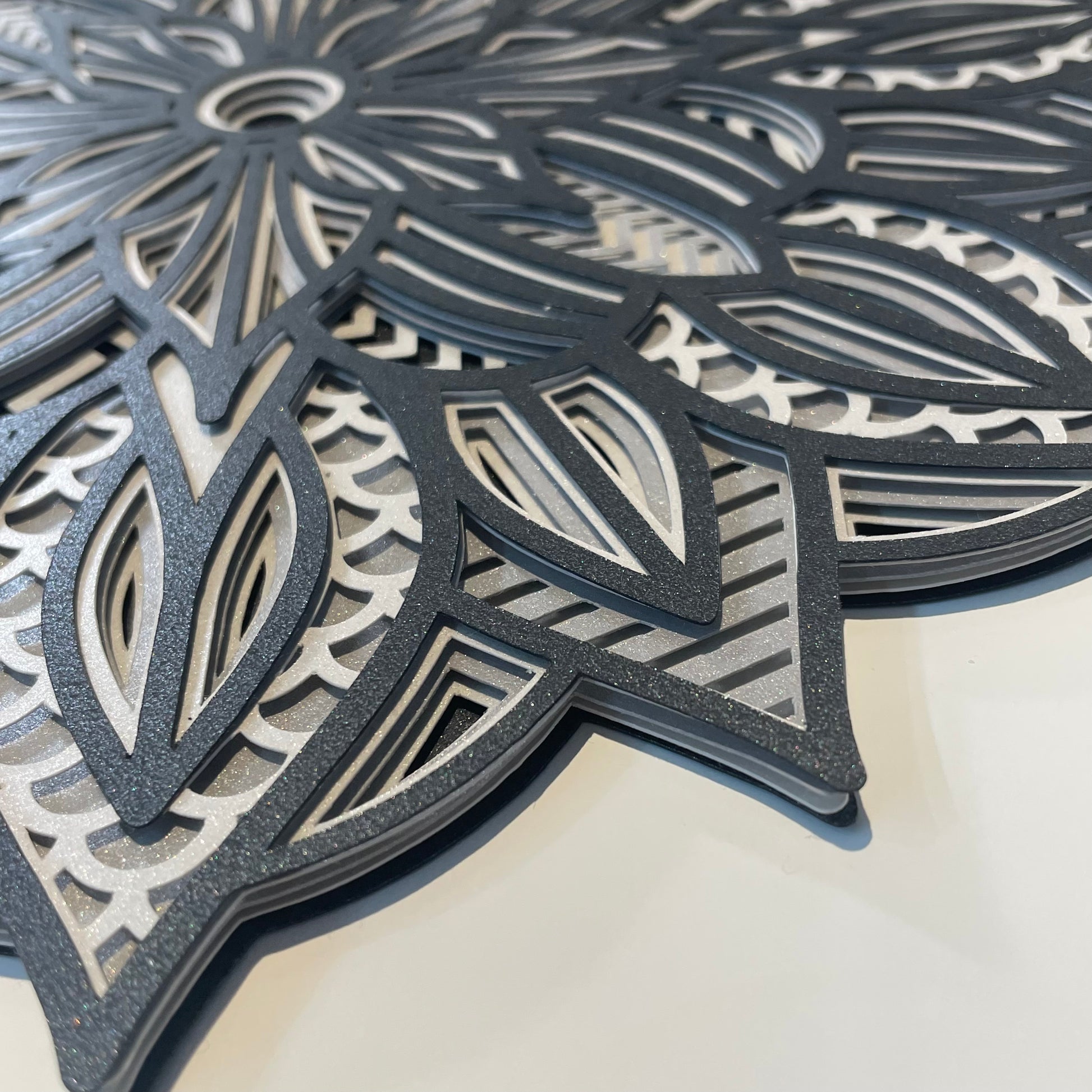 Close up view of a 3d layered Mandala SVG Design by Home Stitchery Decor. We cut this out with our Cricut Maker and you can too! Just follow along with our complete 3d Layered Mandala tutorial. Find your favorite 3d layered Mandala designs by Home Stitchery Decor