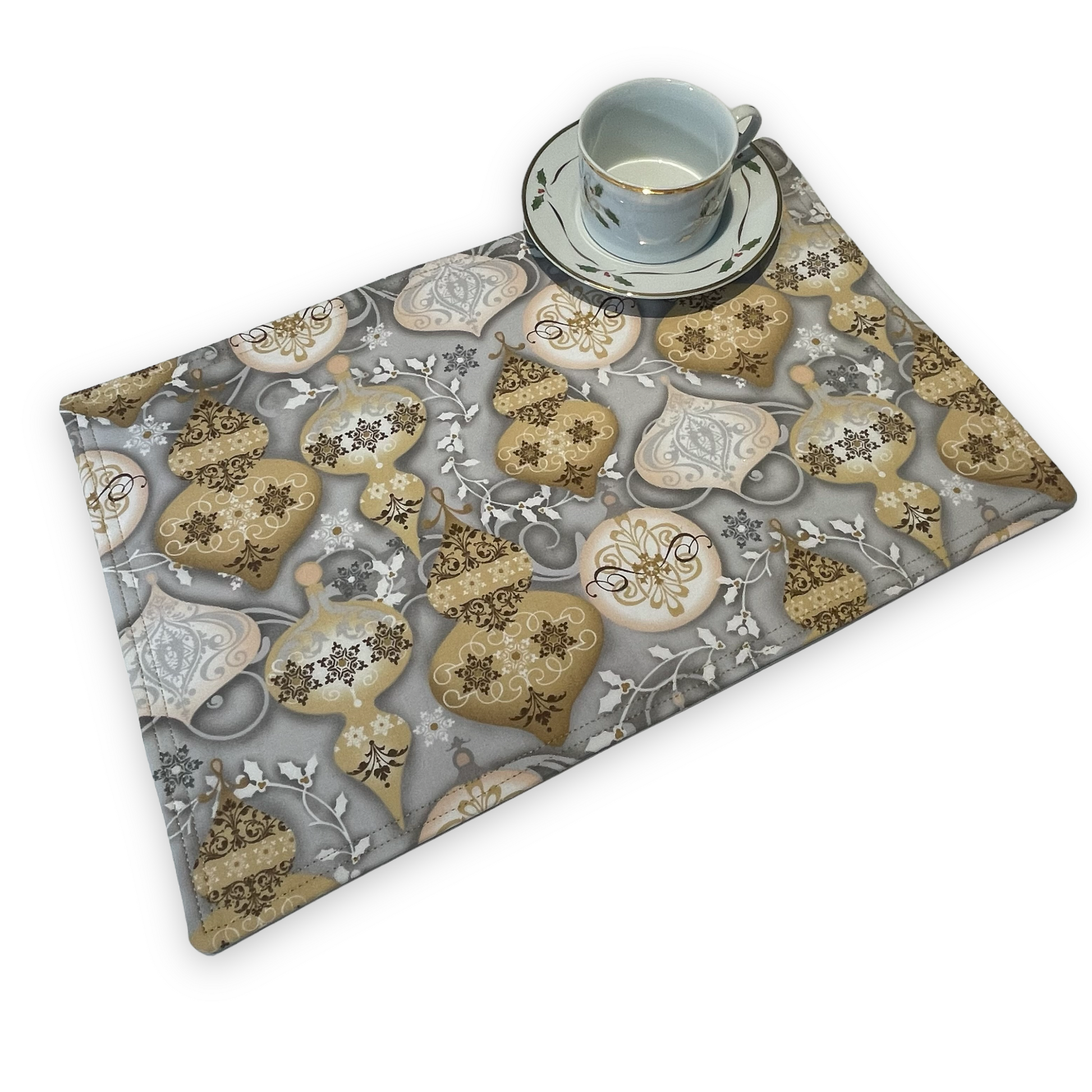 Set of two Christmas Placemats, handmade in Canada Featuring Gold and Cream Christmas Ornaments on one side and Silver Snowflakes on the reverse. Easily dress up your Christmas Kitchen Table with these stylish luxury placemats. Check out all the mix and match decor at Home Stitchery Decor