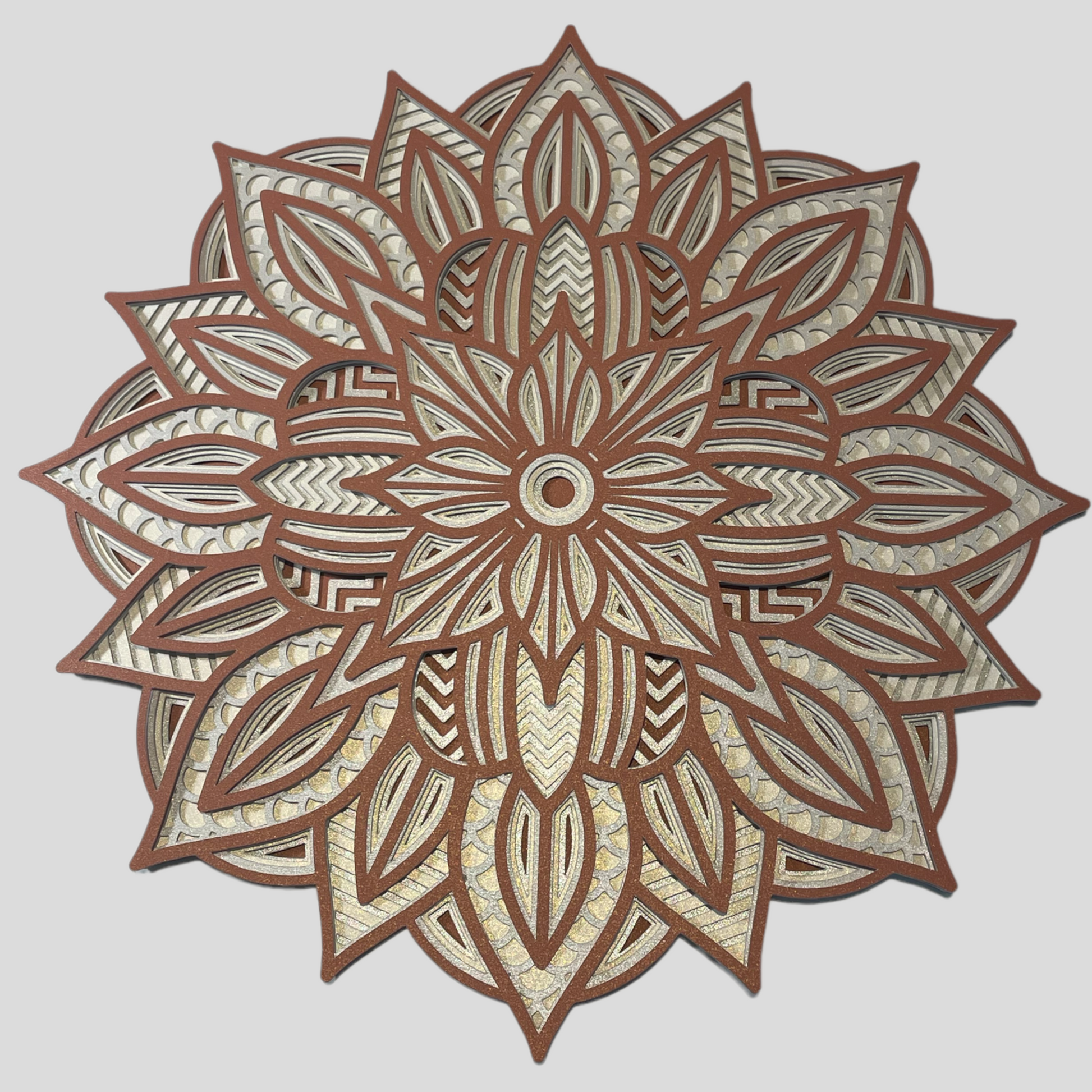 Image showing a 3d Layered Mandala Design which is an instant download SVG design by Home Stitchery Decor.  This 3d Layered Mandala can be cut out with Cricut, Silhouette, CNC or laser machines.  Create your own one-of-a-kind 3d Layered Mandala by following along with the complete tutorial on the Home Stitchery Decor YouTube Channel