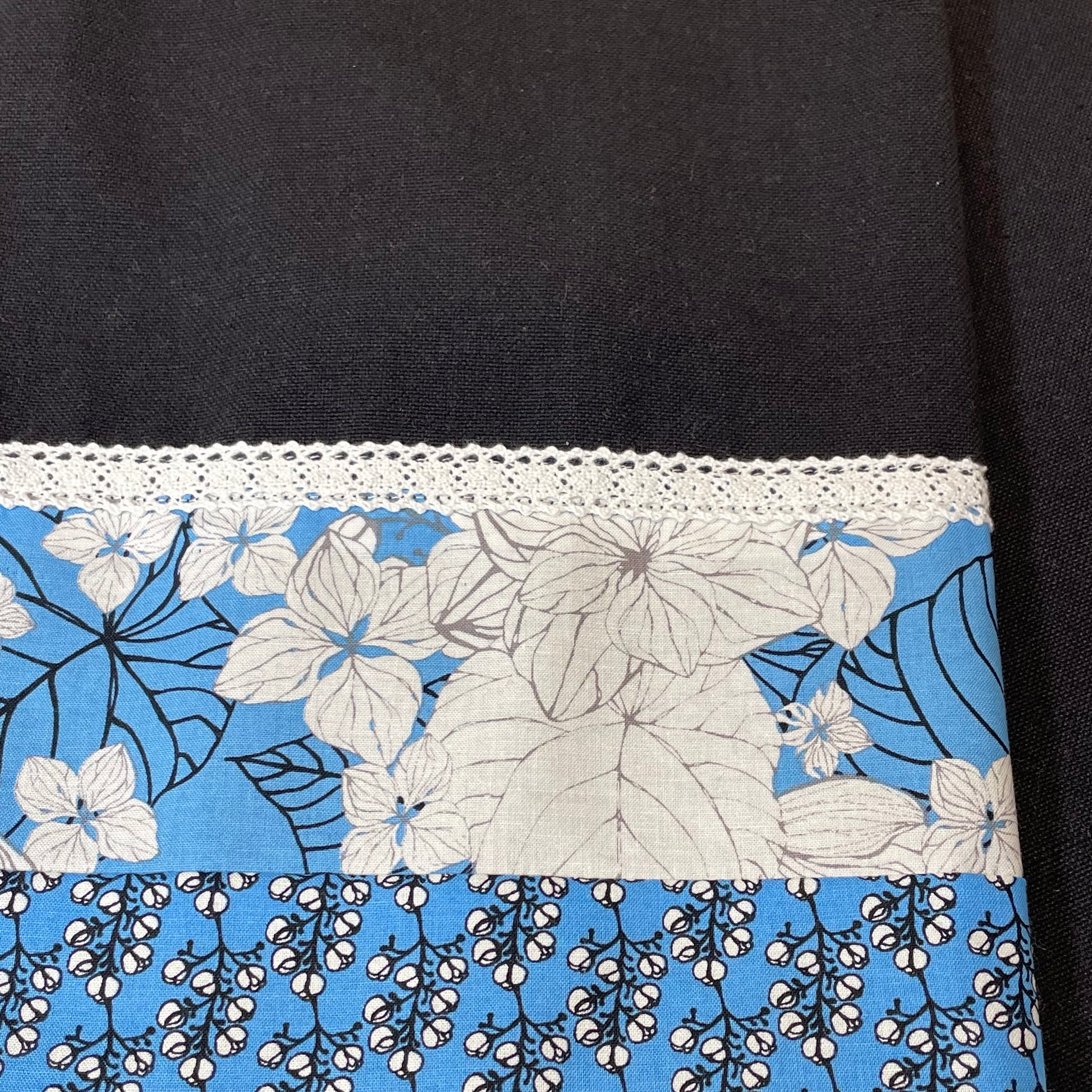 Blue and Black decorative dish towel for your kitchen.  Black toweling with blue and white flower cotton accent material.  White cotton lace trim.  Handcrafted by Home Stitchery Decor.  Find your favorite or watch tutorials on the Home Stitchery Decor YouTube Channel and make your own! 