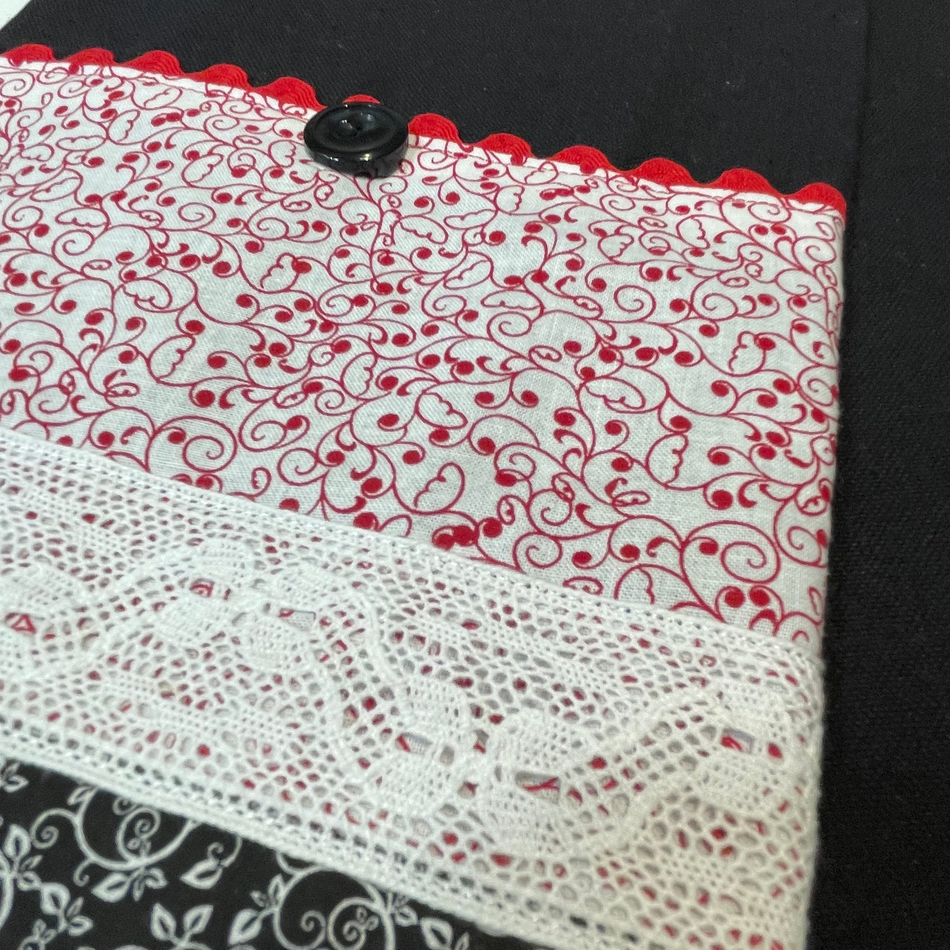 Farmhouse dish towel. Black cotton toweling with quilting cotton accents. Featuring red Ric Rac, wide white polyester lace and button embellishments. Part of a mix and match farmhemian home accents decor line. Browse all the collections online. And be sure to tune into the Home Stitchery Decor YouTube Channel for fabulous fun farmhouse DIY Decor tutorials.