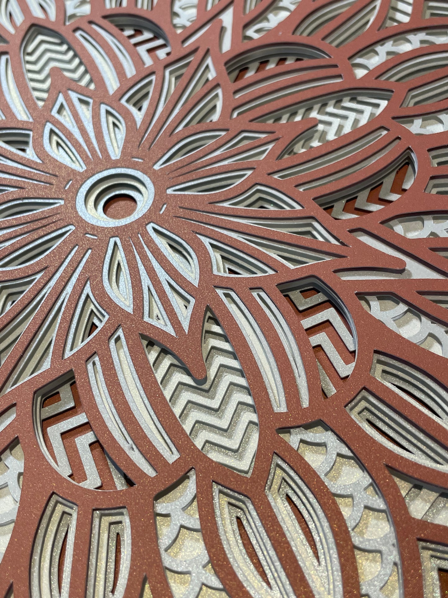 Close up view of a 3d layered Mandala SVG Design by Home Stitchery Decor. We cut this out with our Cricut Maker and you can too! Just follow along with our complete 3d Layered Mandala tutorial. Find your favorite 3d layered Mandala designs by Home Stitchery Decor
