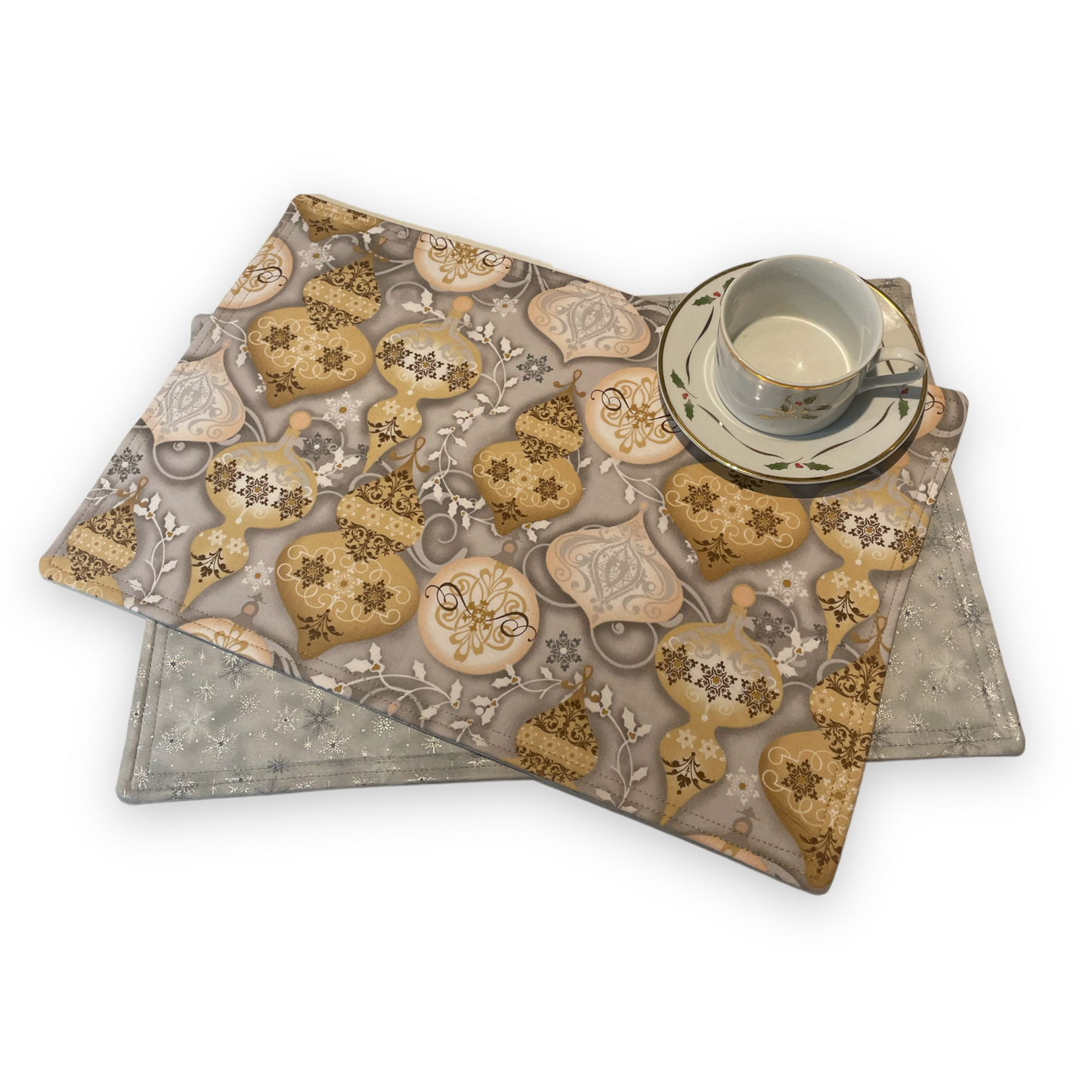 Set of two Christmas Placemats, handmade in Canada Featuring Gold and Cream Christmas Ornaments on one side and Silver Snowflakes on the reverse. Easily dress up your Christmas Kitchen Table with these stylish luxury placemats. Check out all the mix and match decor at Home Stitchery Decor