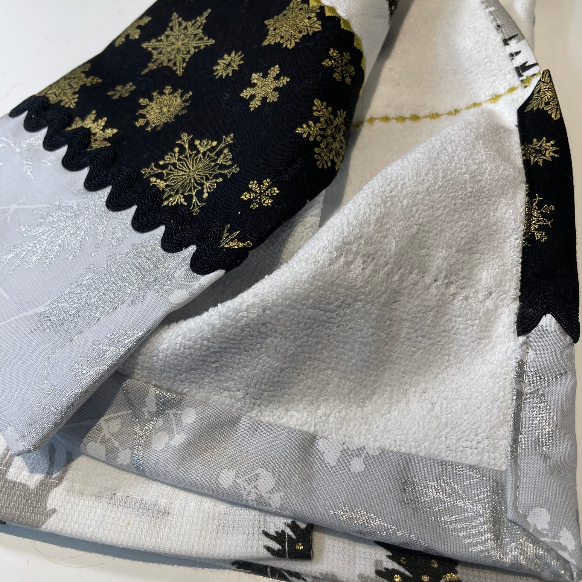 Black and Gold Christmas Dish Towel Featuring Reindeer, Christmas Trees and Snowflakes. Part of a mix and match collection of decor. Shop the look at Home Stitchery Decor and be sure to pop over to the Home Stitchery Decor YouTube Channel