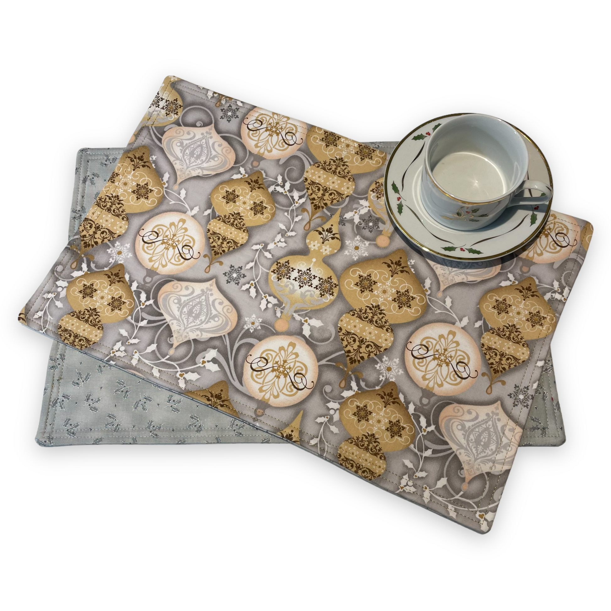 Set of two Christmas Placemats, handmade in Canada Featuring Gold and Cream Christmas Ornaments on one side and Silver Snowflakes on the reverse. Easily dress up your Christmas Kitchen Table with these stylish luxury placemats. Check out all the mix and match decor at Home Stitchery Decor