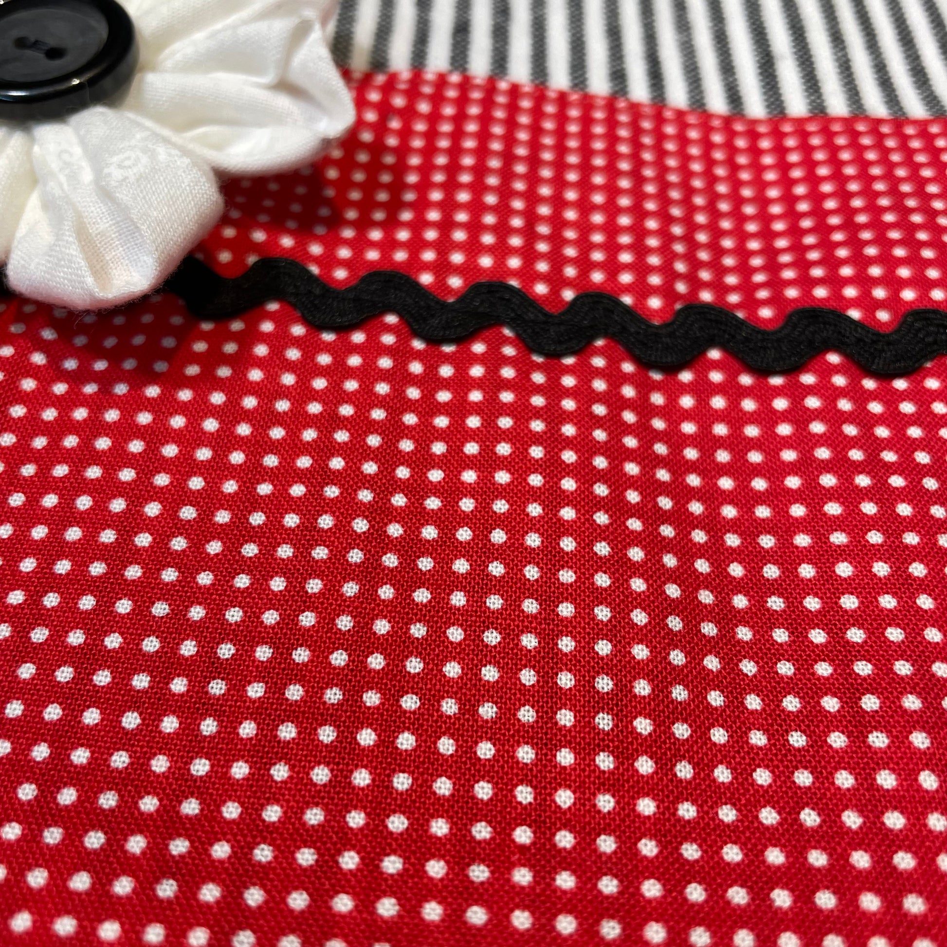 Red, white and black dish towel. With ric rac and hand stitched flower with button center. Farmhouse styled dish towels. This is a mix and match collection. Head over to the website to find all your favorite farmhouse fabulous decor for your entire home. Be sure to follow along on the Home Stitchery Decor YouTube Channel for more farmhouse fun!