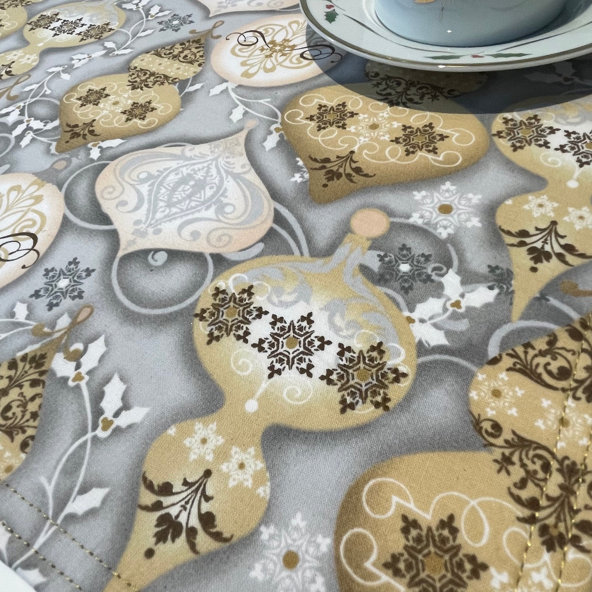 Set of two Christmas Placemats, handmade in Canada Featuring Gold and Cream Christmas Ornaments on one side and Silver Snowflakes on the reverse. Easily dress up your Christmas Kitchen Table with these stylish luxury placemats. Check out all the mix and match decor at Home Stitchery Decor