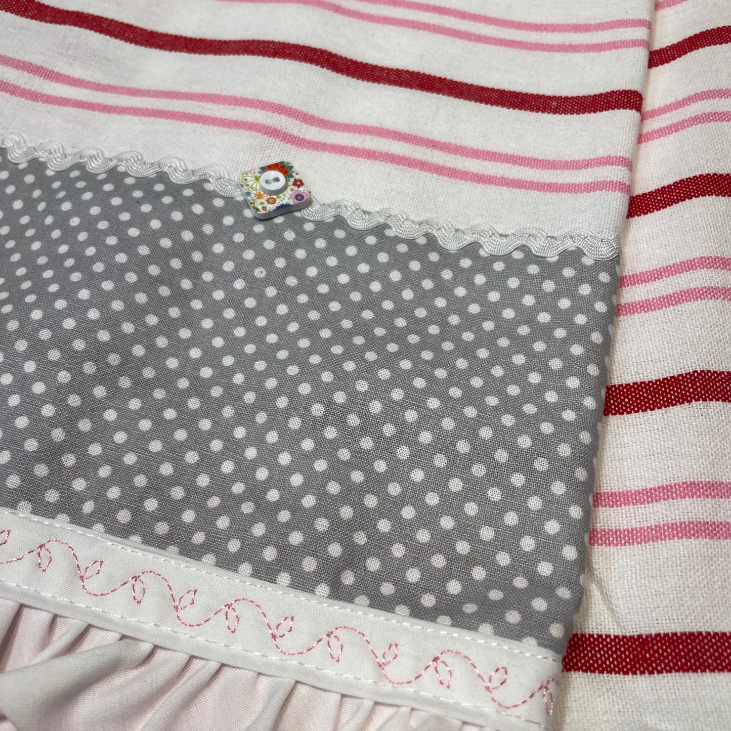 Cute red, white and pink towel with handcrafted quilting cotton accents. Featuring red Ric Rac, white Ric Rac and and heart shaped button. Part of a mix and match collection of coordinated kitchen and bath decor. Browse your favorites and be sure to follow along on the Home Stitchery Decor YouTube Channel