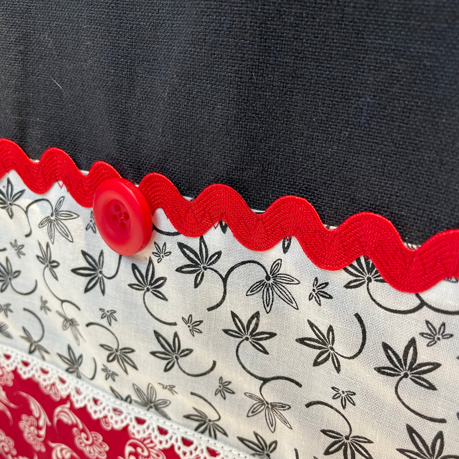 Farmhouse dish towel. Black cotton toweling with quilting cotton accents. Featuring red Ric Rac, white delicatepolyester lace and button embellishments. Part of a mix and match farmhemian home accents decor line. Browse all the collections online. And be sure to tune into the Home Stitchery Decor YouTube Channel for fabulous fun farmhouse DIY Decor tutorials.