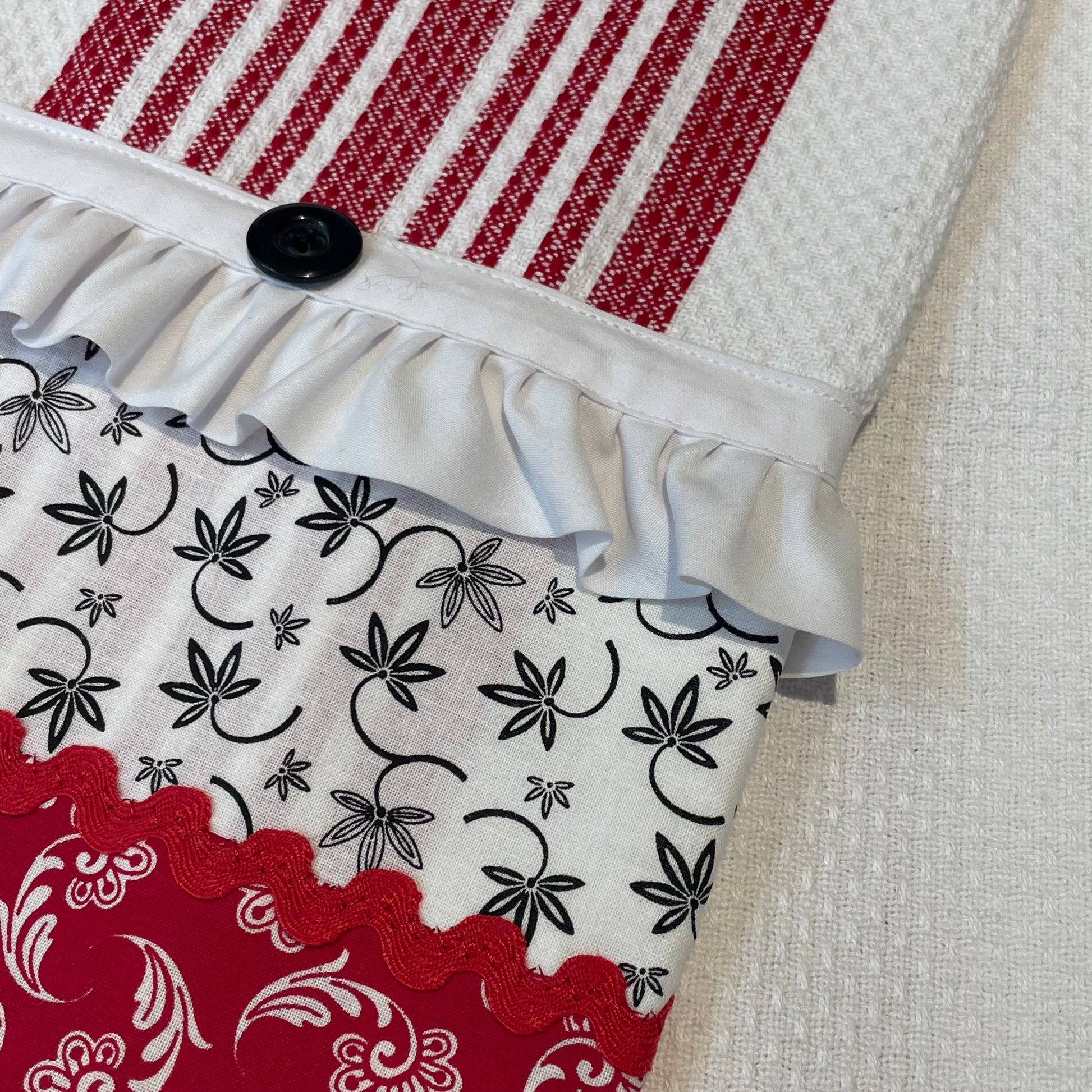 Red and white country style dish towel. Featuring red and white checked toweling; red white and black quilt cotton accents and white cotton lace trim and a double button embellishment. Part of a mix and match collection of coordinated farmhouse fabulous decor. Browse the collections and be sure to check out the Home Stitchery Decor YouTube Channel.