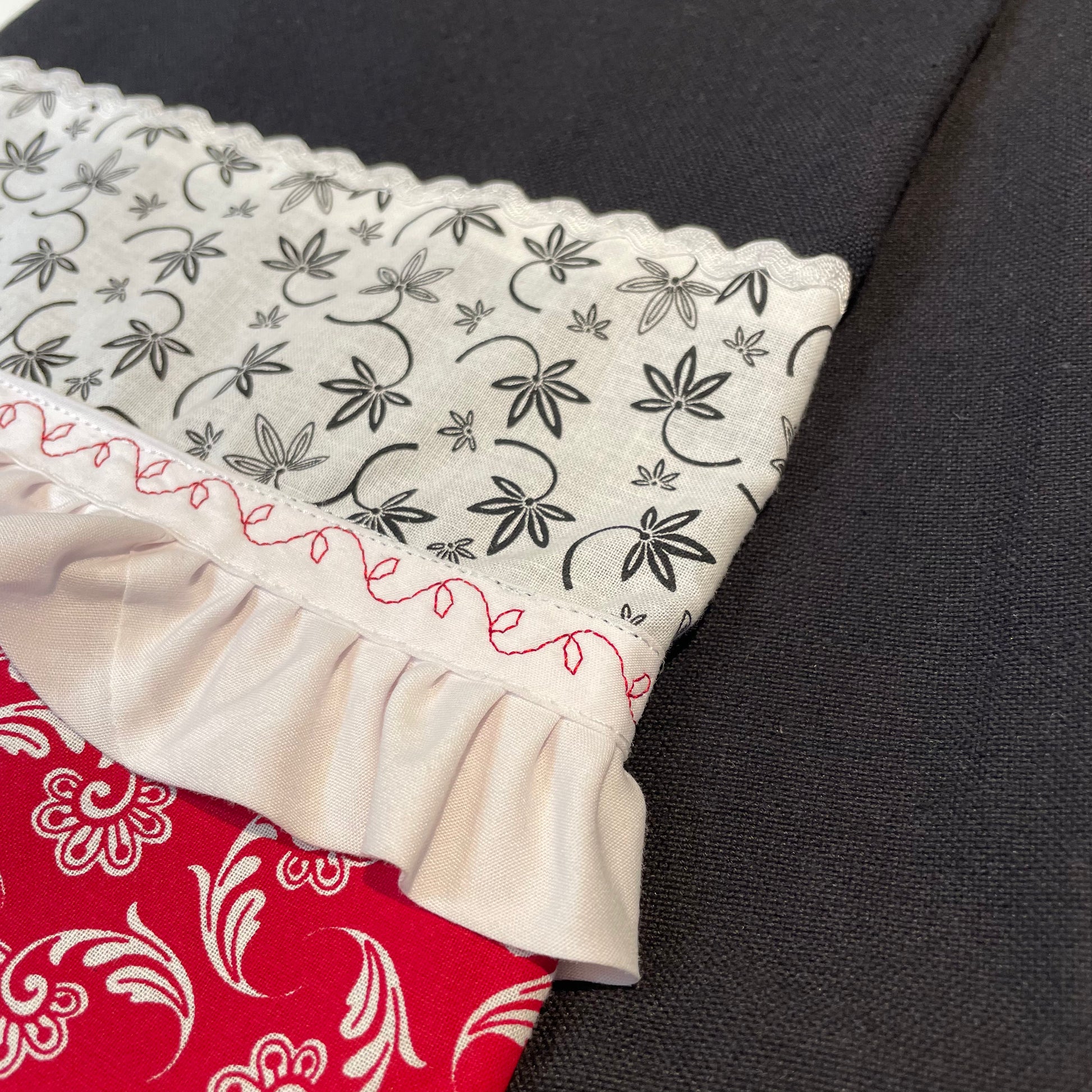 Farmhouse Kitchen Dish Towel featuring black toweling and quilt cotton accents. Embellished with white Ric Rac and Frilled Broadcloth with red embroidery stitching. Part of a collection of mix and match farmhemian styled home decor. Browse the entire collections online. Then head on over to the Home Stitchery Decor YouTube Channel for more Farmhouse DIY Decor fun!