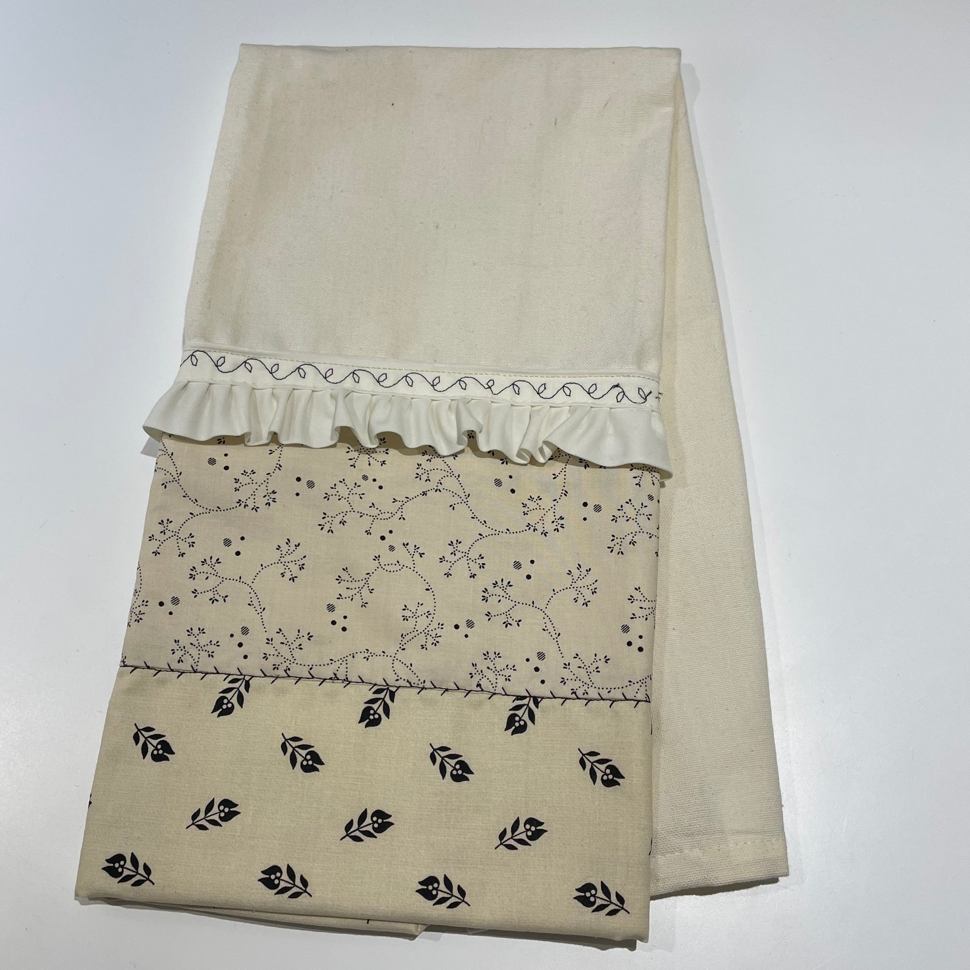 Handcrafted in Canada Farmhouse Style Dish Towel with black flowers on a beige cotton towel and embroidery details. Purchase this product or learn to make your own on the Home Stitchery Decor YouTube Channel. Part of a coordinating product line. 