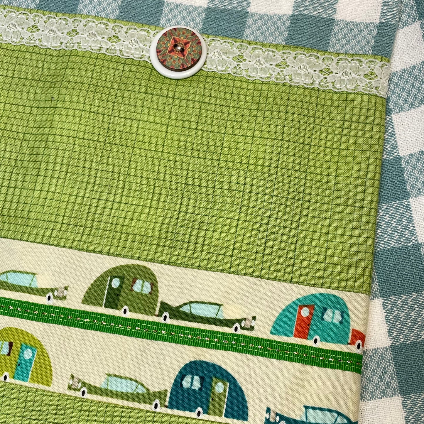 White and Teal Checked Kitchen Dish Towel with cute retro boler trailers, white and green trim and button. A perfect gift for the glamper in your life. Find this and coordinating products on the website. Or follow along on the Home Stitchery Decor YouTube channel, featuring sewing and Cricut tutorials.