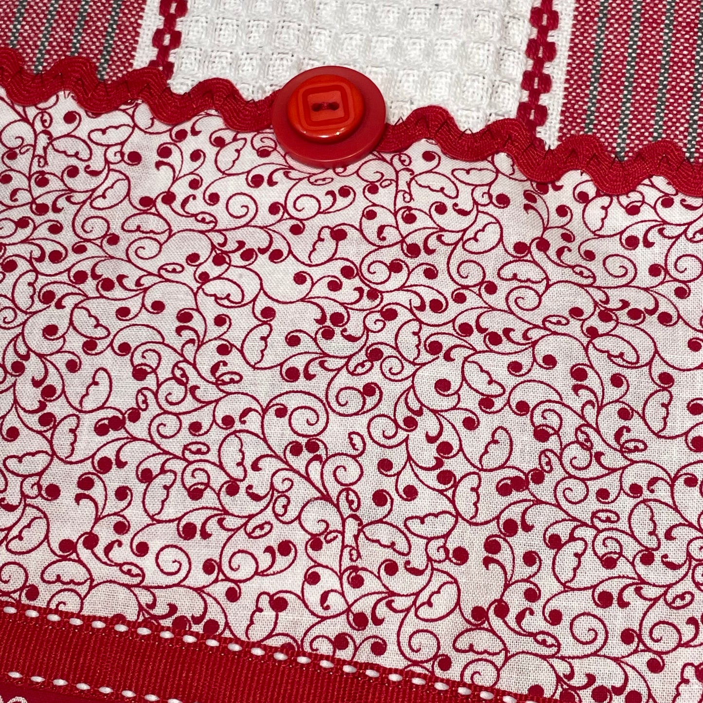Red and White Kitchen Dish Towel with quilting cotton accents. Featuring Embroidery, Ric Rac and and Button Details. Part of a mix and match collection. Browse the entire line of coordinated products exclusive to Home Stitchery Decor. And be sure to watch the Home Stitchery Decor YouTube Channel.
