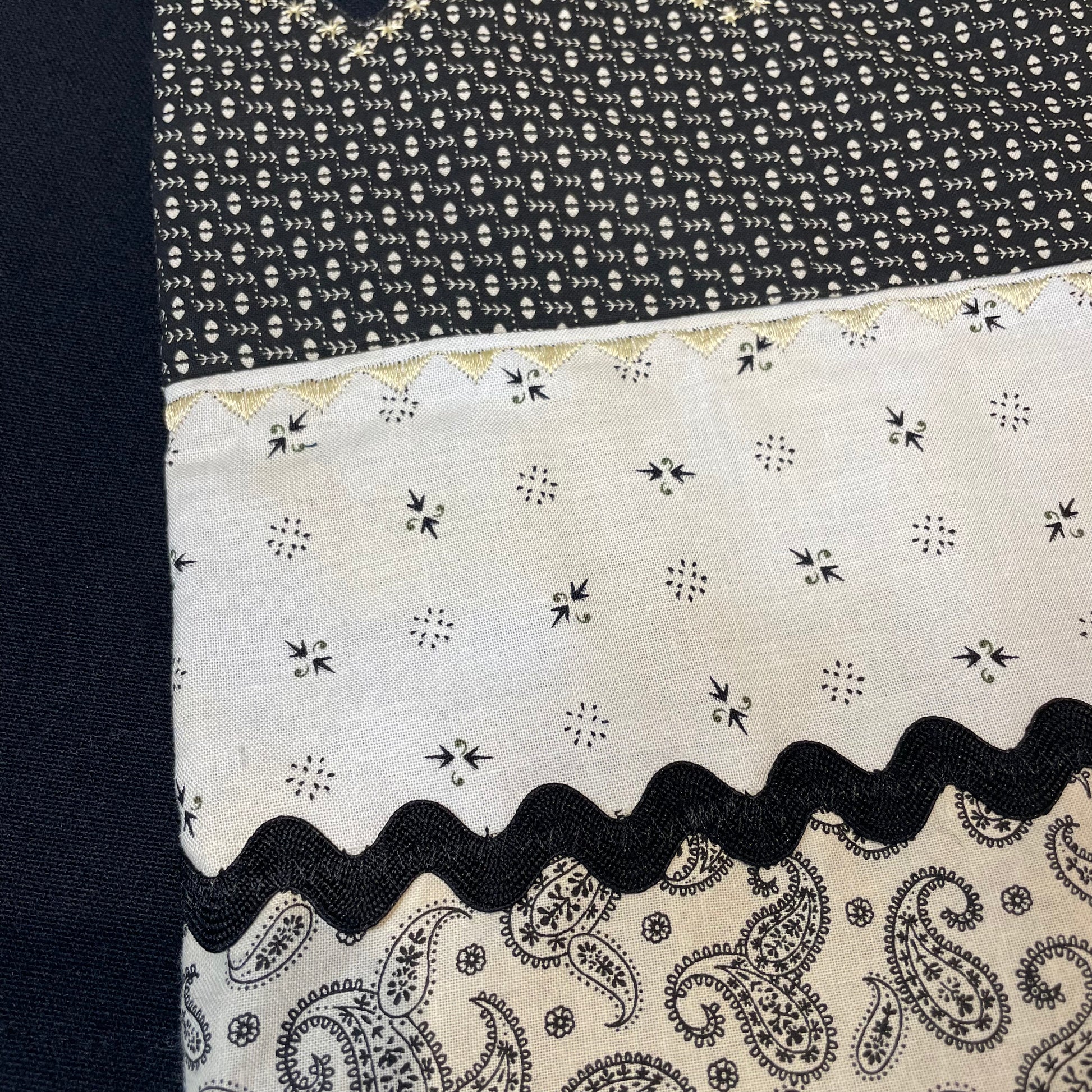 Black kitchen towel with cottage core style details. Black and cream quilt cotton accent fabric with Ric Rac and Embroidery Stitching. Part of a collection of coordinated farmhouse style linens. Shop the look on the website, find me in a local store or Farmers Market. Or follow along on the Home Stitchery Decor YouTube Channel tutorials for fabulous farmhouse style diy decor. And  SVG Mandala Patterns. 