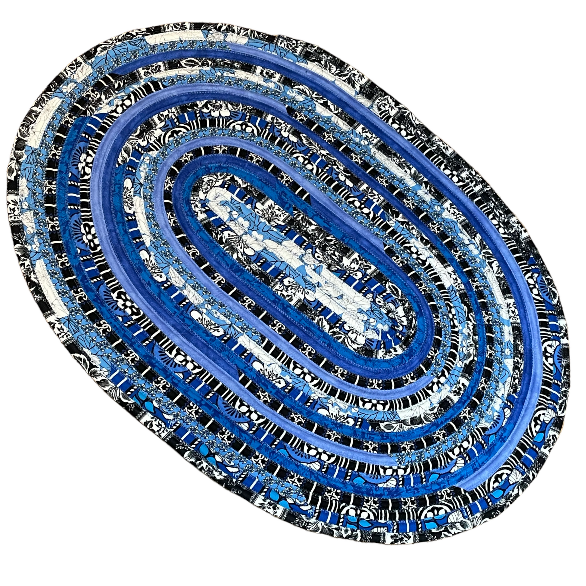 Vibrant blue, black and white kitchen accent rug. Washable handcrafted kitchen accent rug. Can also be used as a bedside rug, luxury bathmat or nursery room rug. Made in Canada and part of a collection of mix and match decor. Shop all the products or follow along on the Home Stitchery Decor YouTube Channel for sewing tutorials including JellyRoll Rug Tutorials.