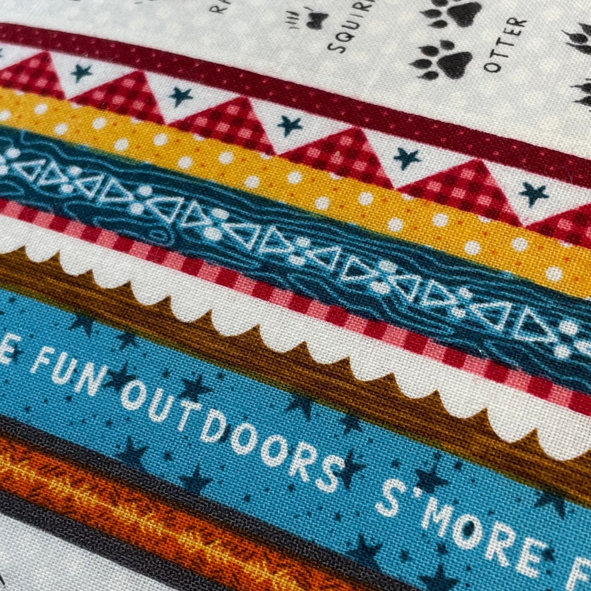 Camping Decorative Pillow for your RV, Camper Decor. Let's go camping with mix and match decor. Shop the collection and follow along on the Home Stitchery Decor YouTube Channel. Pillow in white, teal, red, yellow and black. Woodland tracks camping themed pillow.