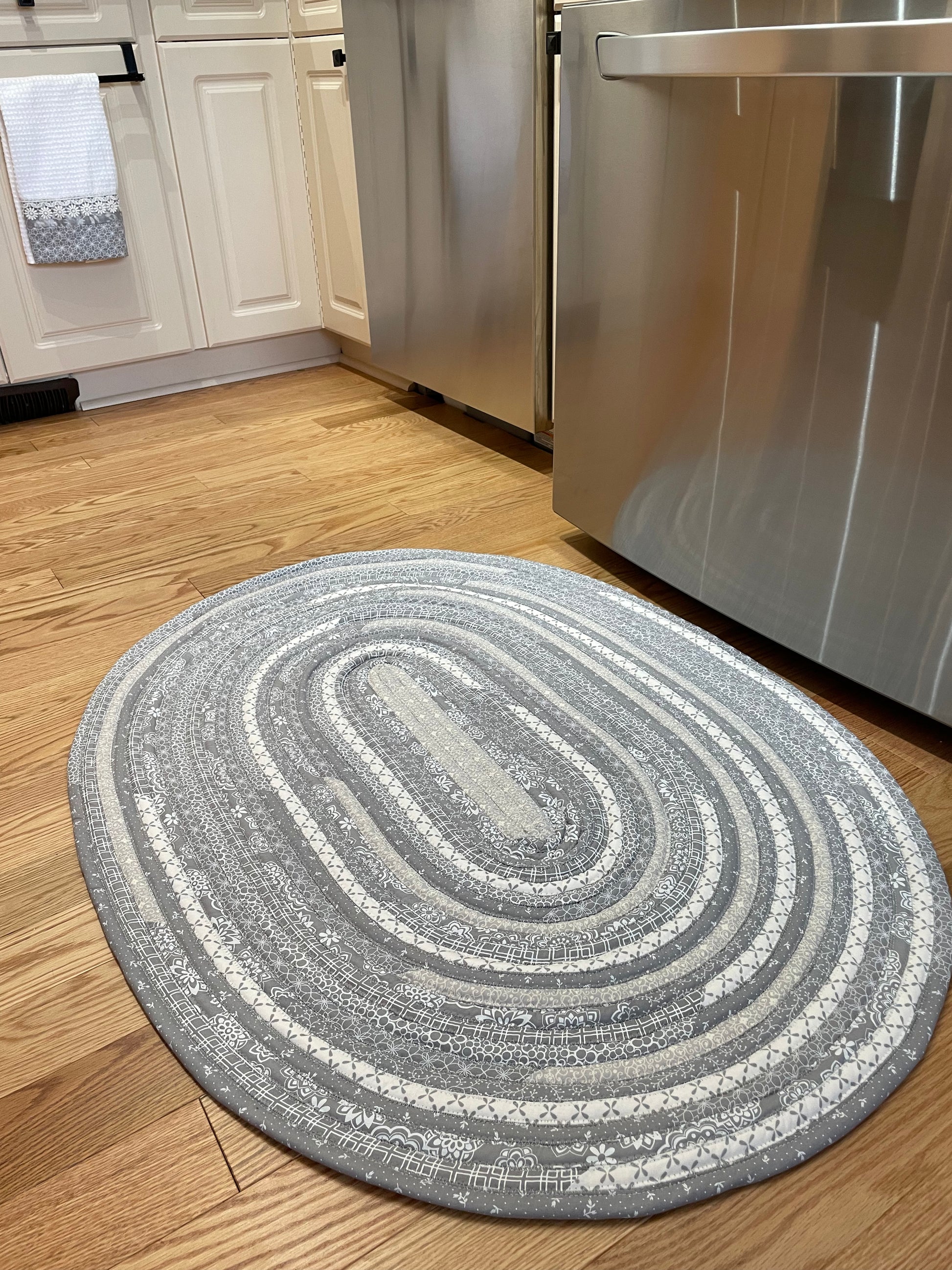 Grey and White Modern Farmhouse Kitchen Accent Rug. Can be used as a luxury bathmat, or bedside rug. Washable, Cotton and made in Canada with globally sourced supplies. Matching dish towels and shower curtains also available. Check out the Home Stitchery Decor YouTube Channel.