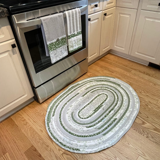 Green and grey cotton kitchen, bedside or bathmat accent rug.  Washable and handcrafted exclusively by Home Stitchery Decor.  Part of a mix and match collection. Features high quality quilting cotton exterior and Pellon Batting fill.  One of a kind.