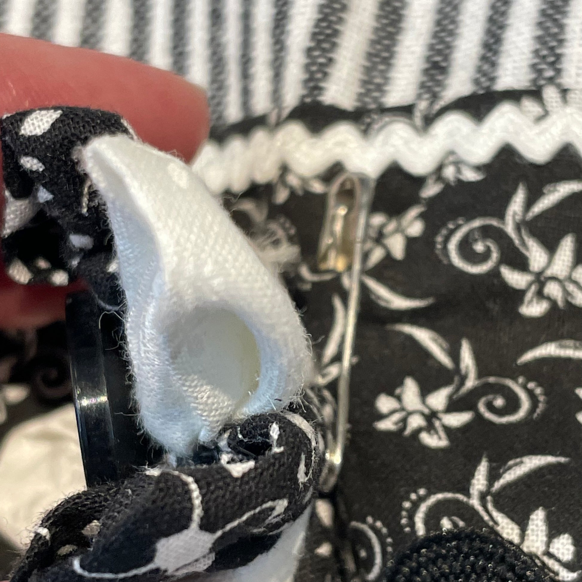 Black and white retro farmhouse tea towel. Featuring black and white striped toweling. Black and white floral quilting cotton accents with white and black ric rac, a handcrafted flower with button center and embroidery stitching. Part of a coordinating collection of farmhouse decor. Browse the entire collection. Then head over to the Home Stitchery Decor YouTube Channel for more Farmhouse DIY Decor Fun. See you there!